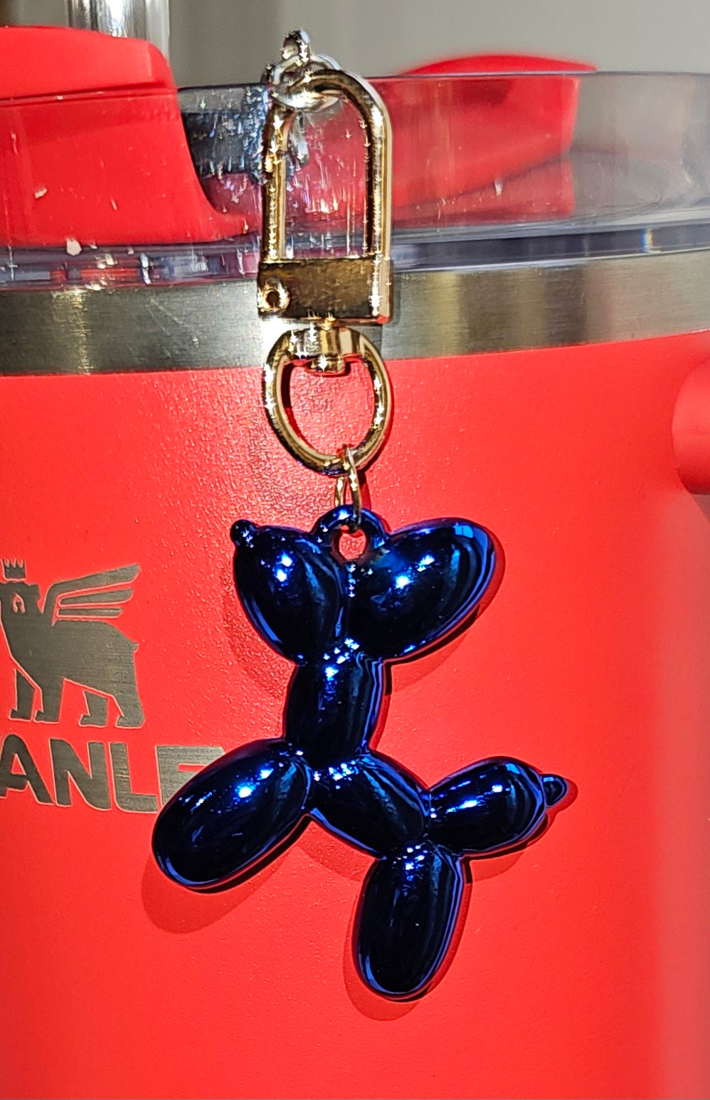 Balloon Dog Charm Pendant. Image with camera flash