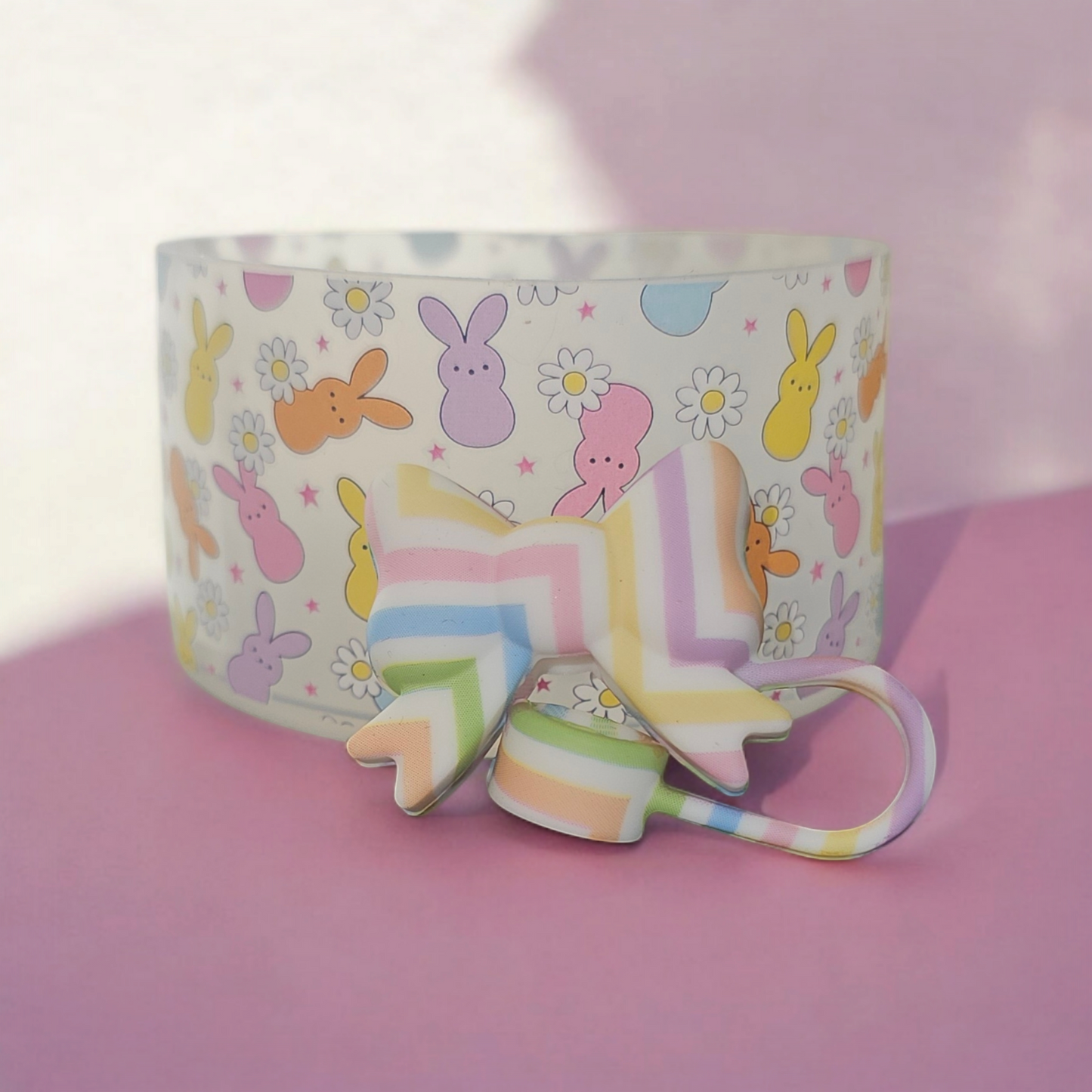 Easter Peeps Clear silicone tumbler boot and Easter Egg Stripes 3D Coquette Ribbon Bow Silicone Straw Topper Set. Colors are pink, purple, blue, white, orange, and yellow.