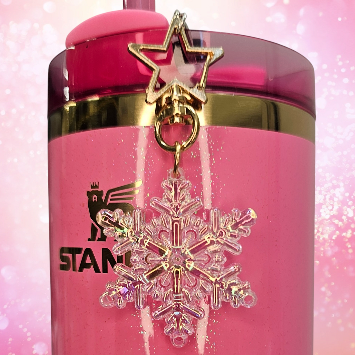 Pearlescent pink Snowflake tumbler straw charm with gold star clasp. Taken without flash.