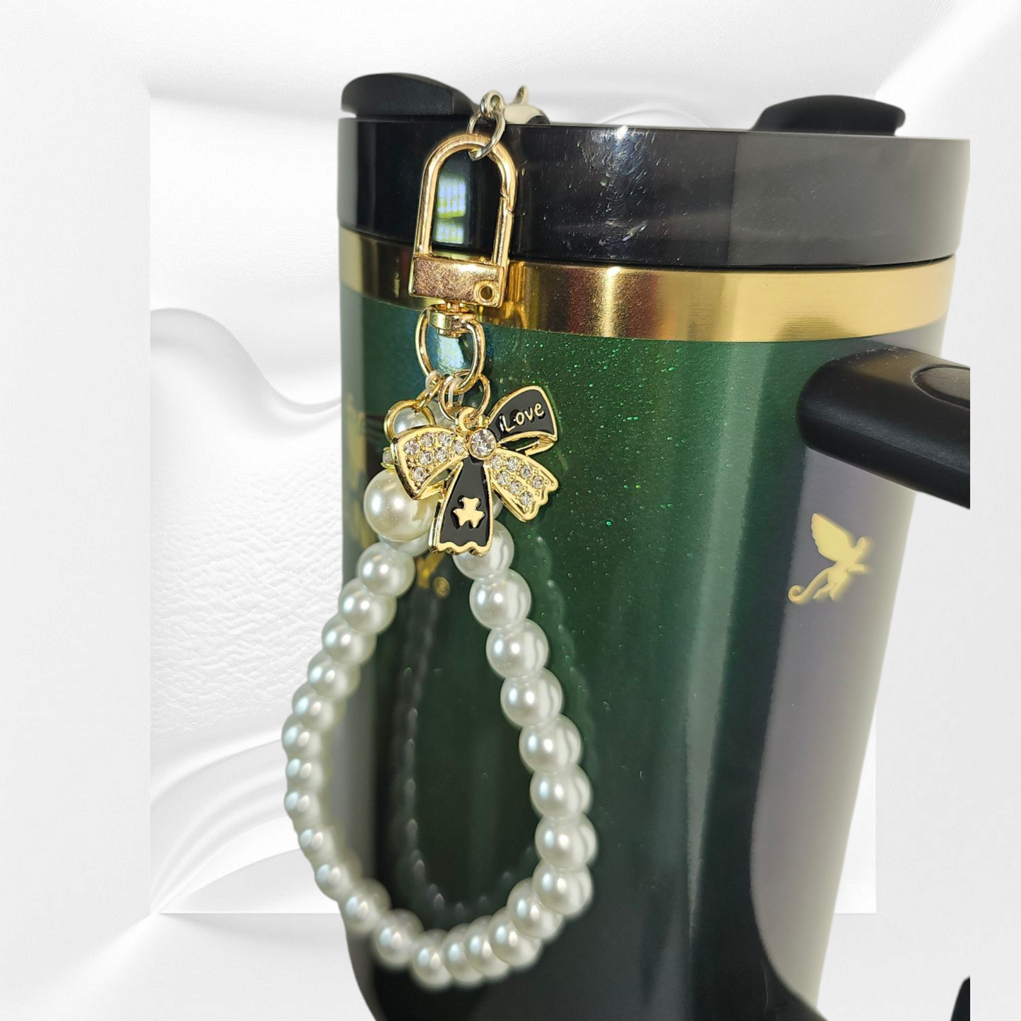 Gold and black Ribbon Bow and Faux Pearl Beaded Tumbler Charm Bracelet. Can be used as cellphone charm Bracelet. Comes with cellphone card adaptor.