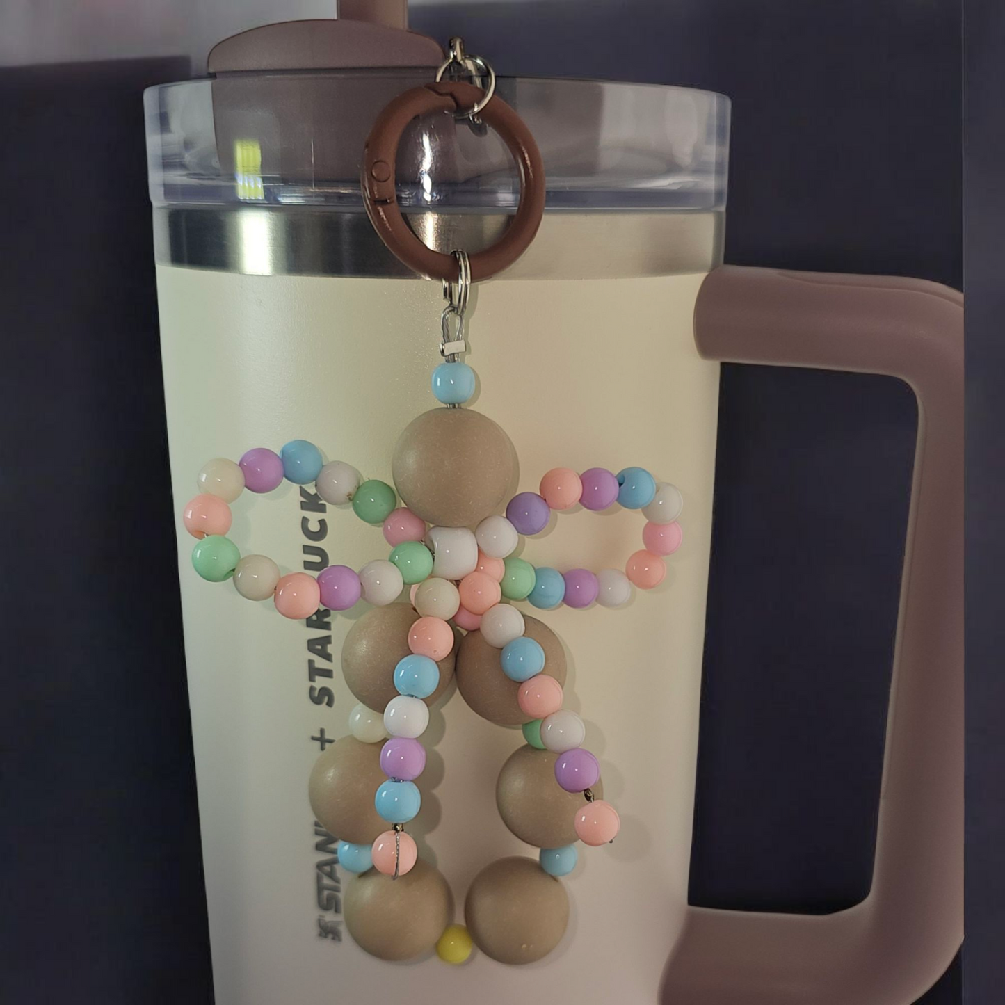 Jump brown beaded charm pendant with multicolor pastel beaded ribbon bow tumbler charm.
