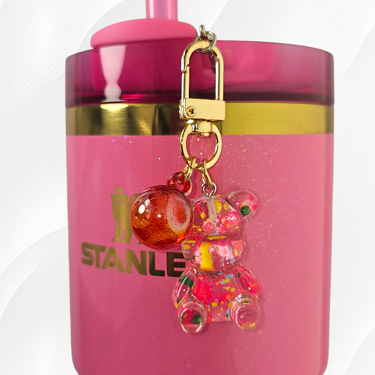 Transparent pink teddy bear with green and yellow specks. Use as a tumbler, purse, or keychain charm.
