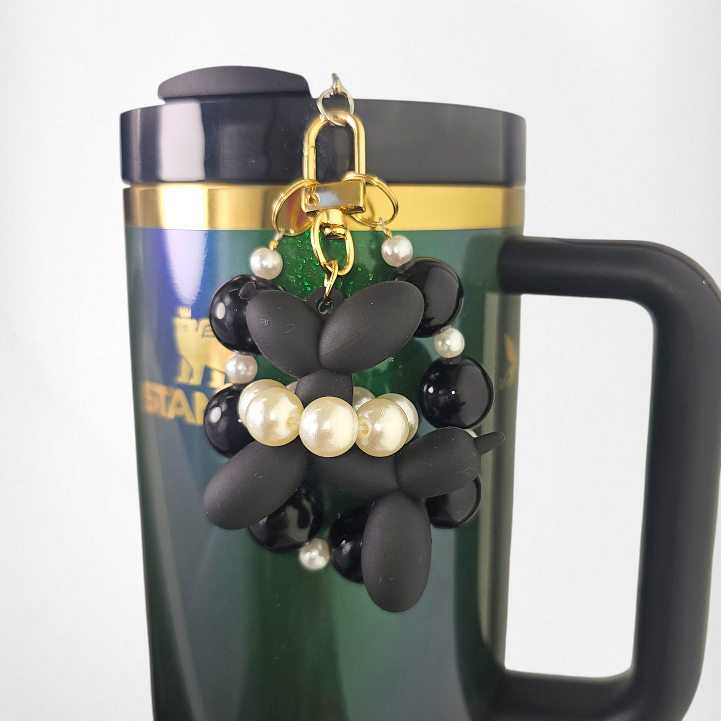 Black Balloon Dog wearing a white pearl beaded necklace with a black beaded charm bracelet. Use as a tumbler, purse, or keychain charm.