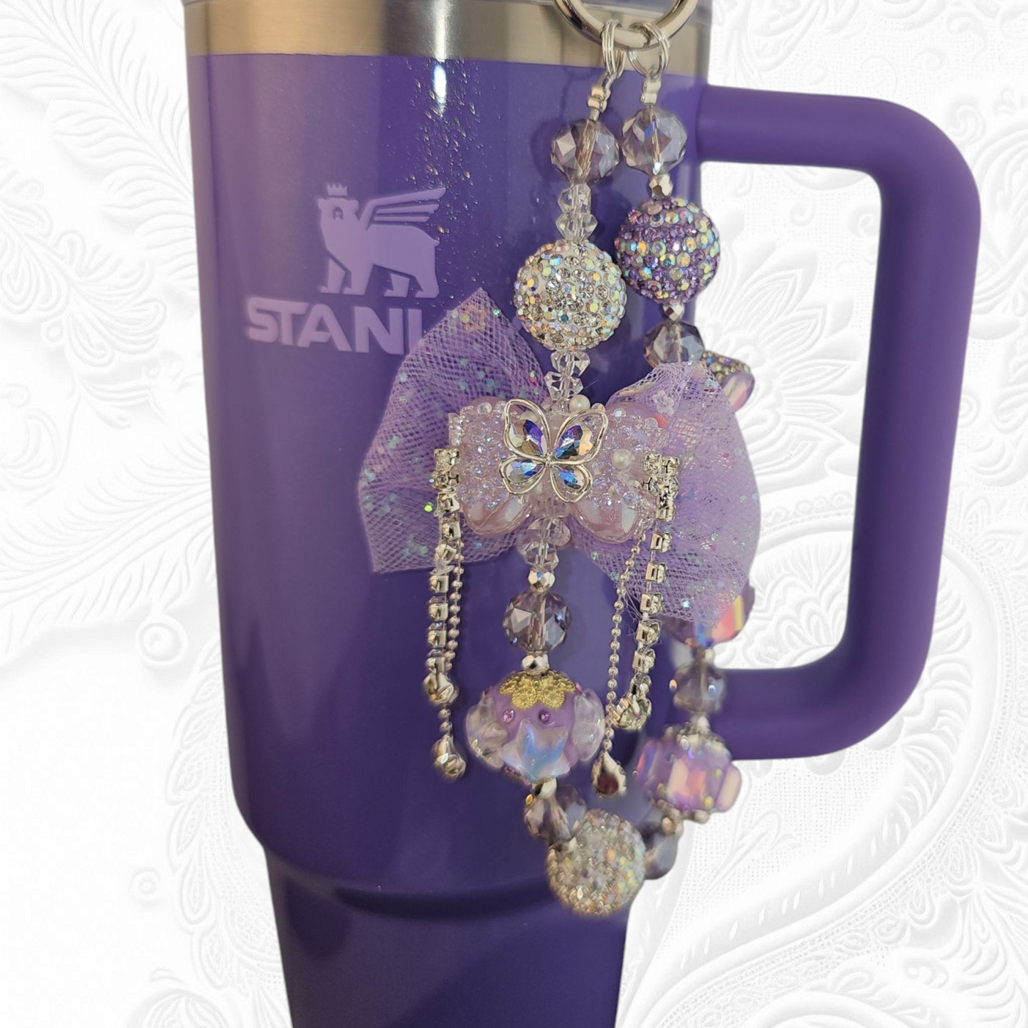 Deluxe Princess Beaded Tumbler Charm Necklace - Lavender Purple
Iridescent Pearlescent Lavendar Purple Crystal Beaded Tumbler Charm Necklace.
The center piece of this beautiful charm is the Jumbo Purple bow tie that is double-sided. One side has a purple sequin star while the other side has a crystal butterfly and diamonds. (diamonds are not real)