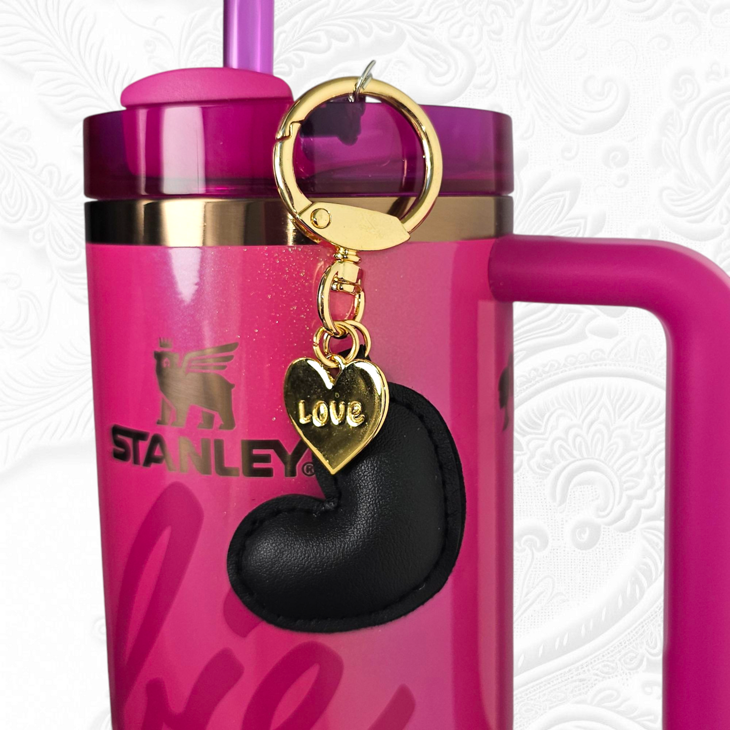 Black leather heart and gold heart tumbler straw charm.