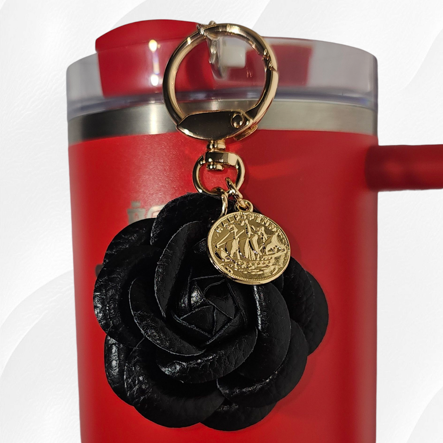 Black Camelia flower with gold swivel keyring tumbler charm.