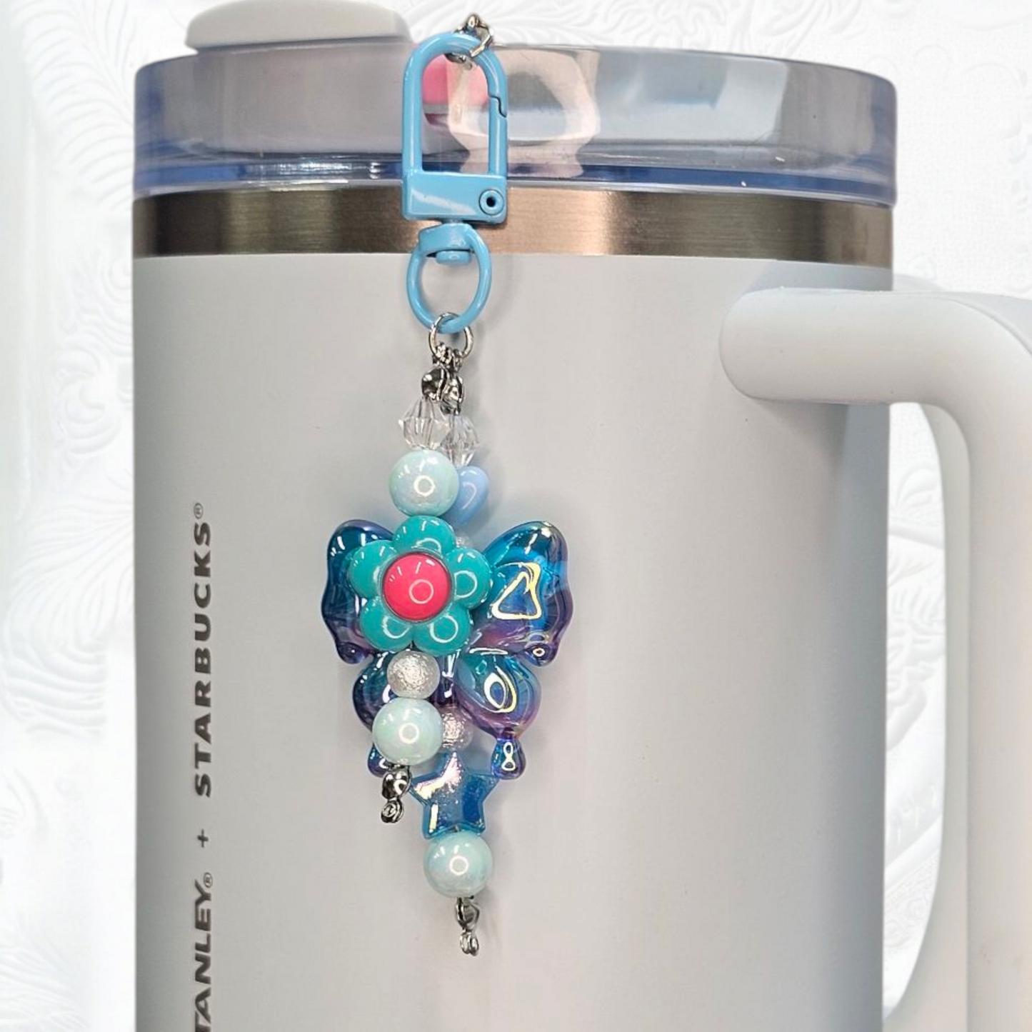 Irrelevant Pearlescent Blue Ombre Butterfly, Pink & Blue Daisy Flower, and Blue Beaded Charm Pendant.