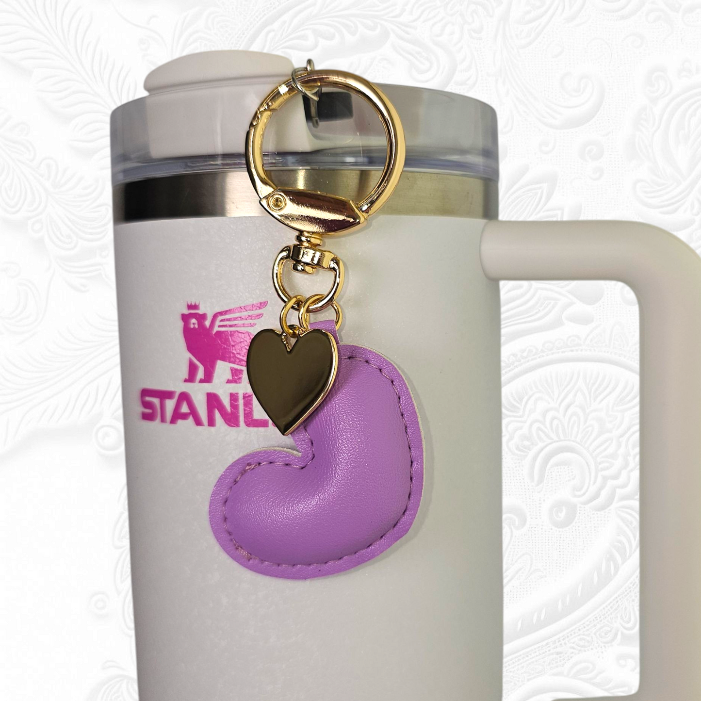 Purple leather heart and gold heart tumbler straw charm.
