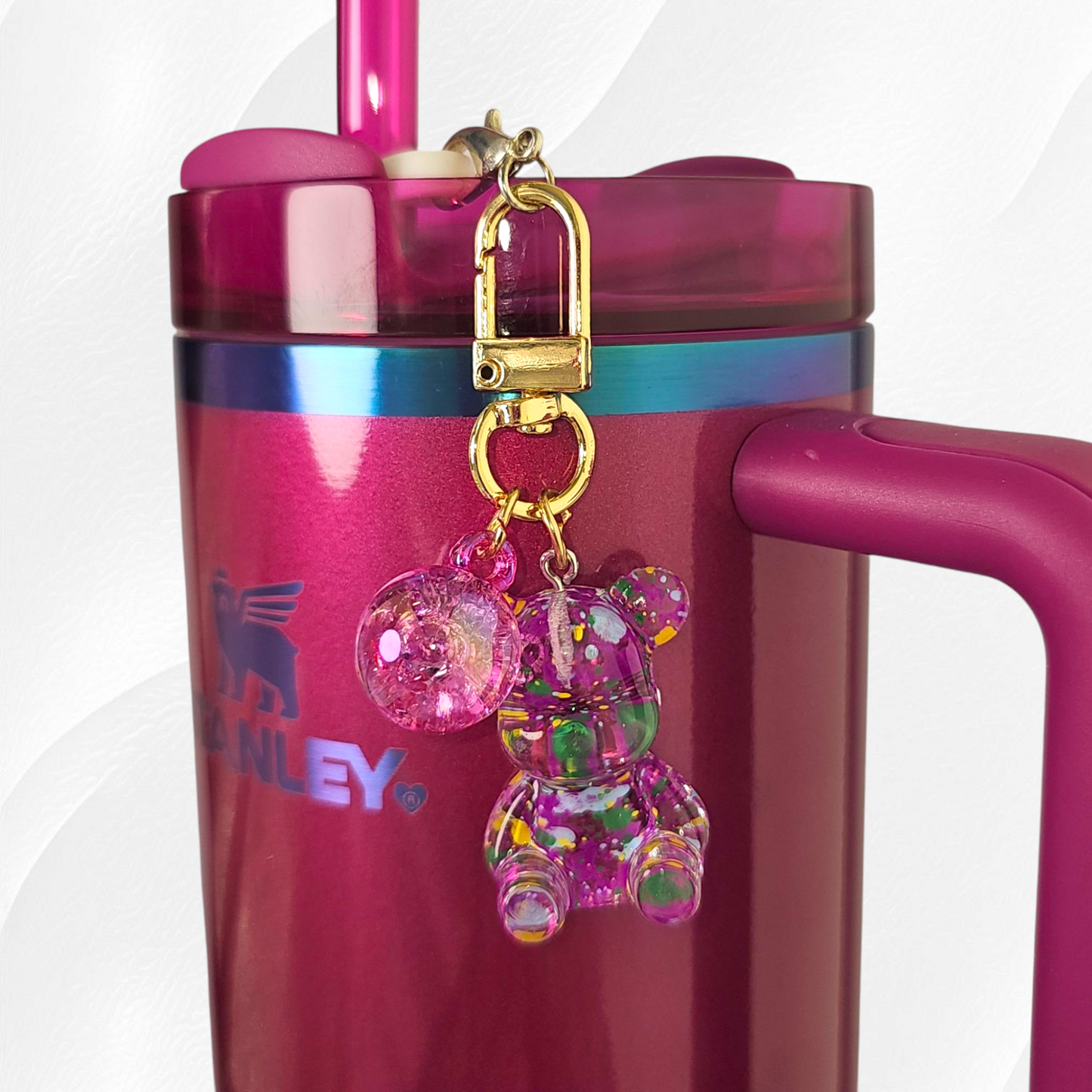 Transparent berry truffle purple teddy bear with green and yellow specks. Use as a tumbler, purse, or keychain charm.