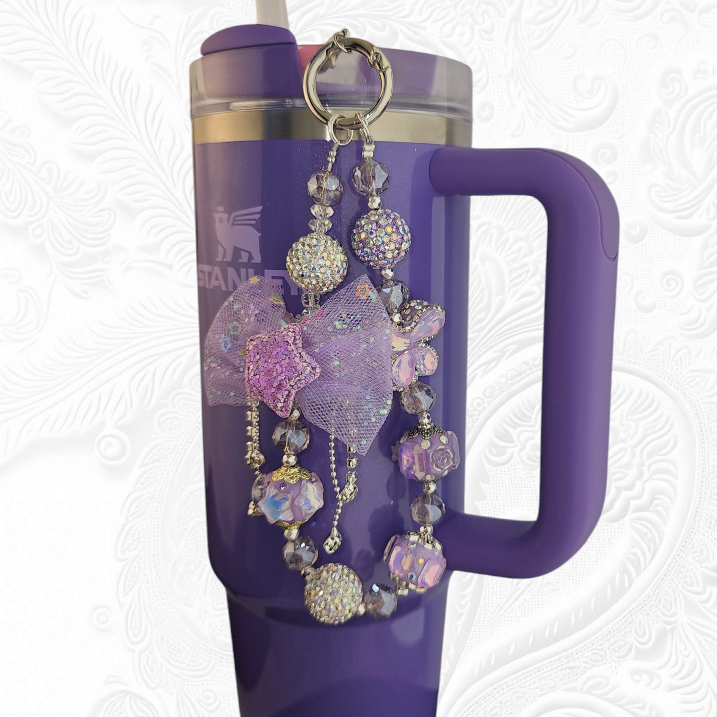Deluxe Princess Beaded Tumbler Charm Necklace - Lavender Purple
Iridescent Pearlescent Lavendar Purple Crystal Beaded Tumbler Charm Necklace.
The center piece of this beautiful charm is the Jumbo Purple bow tie that is double-sided. One side has a purple sequin star while the other side has a crystal butterfly and diamonds. (diamonds are not real)