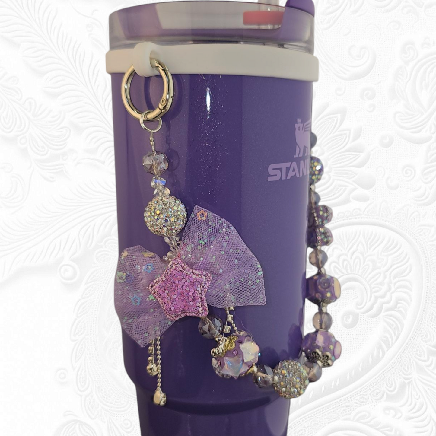 Deluxe Princess Beaded Tumbler Charm Necklace - Lavender Purple
Iridescent Pearlescent Lavendar Purple Crystal Beaded Tumbler Charm Necklace.
The center piece of this beautiful charm is the Jumbo Purple bow tie that is double-sided. One side has a purple sequin star while the other side has a crystal butterfly and diamonds. (diamonds are not real)