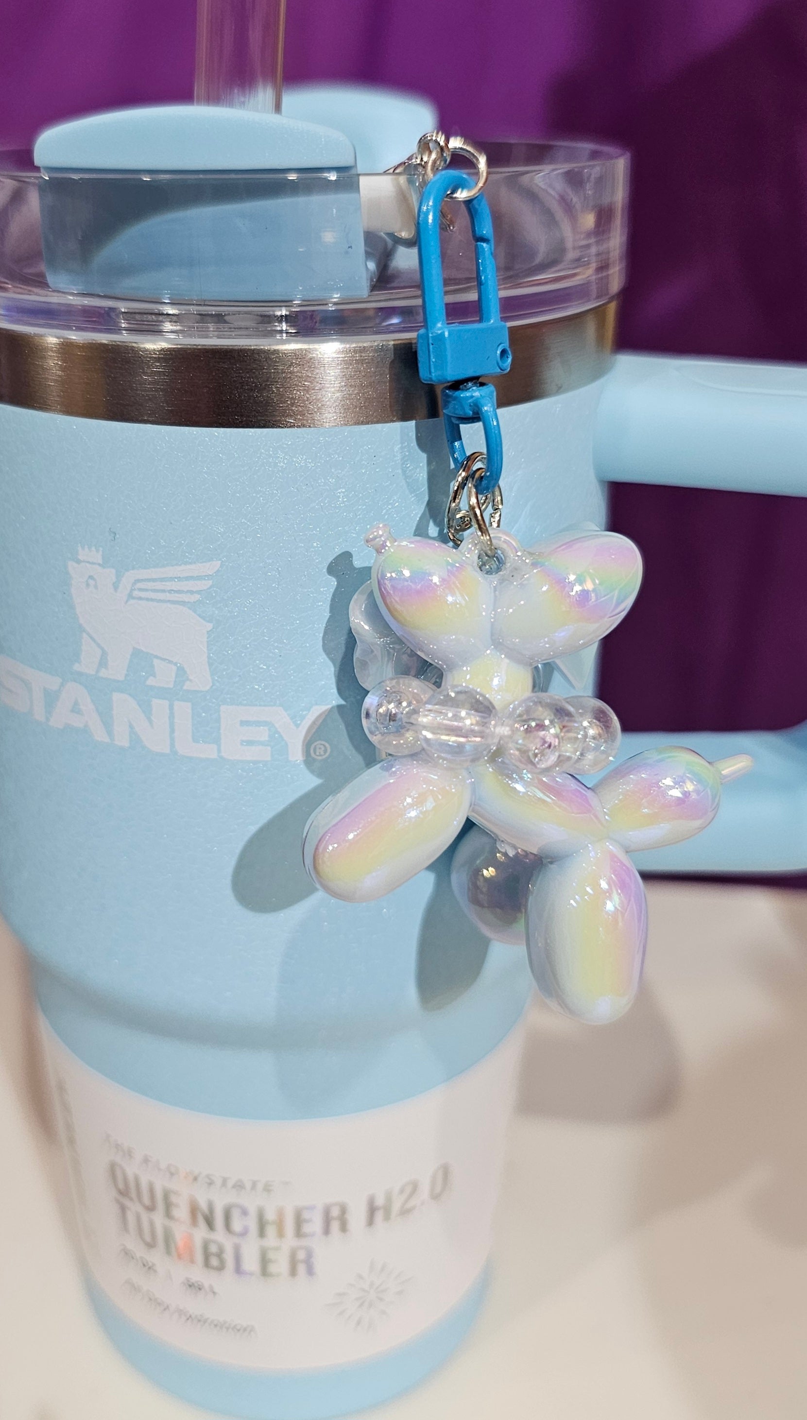 Iridescent Pearlescent Spring Blue Balloon Dog with Ribbon Bow and bead charm pendant. Use to accessorize tumbler straw, tumbler handle, purse, backpack, keychain, or cellphone. 