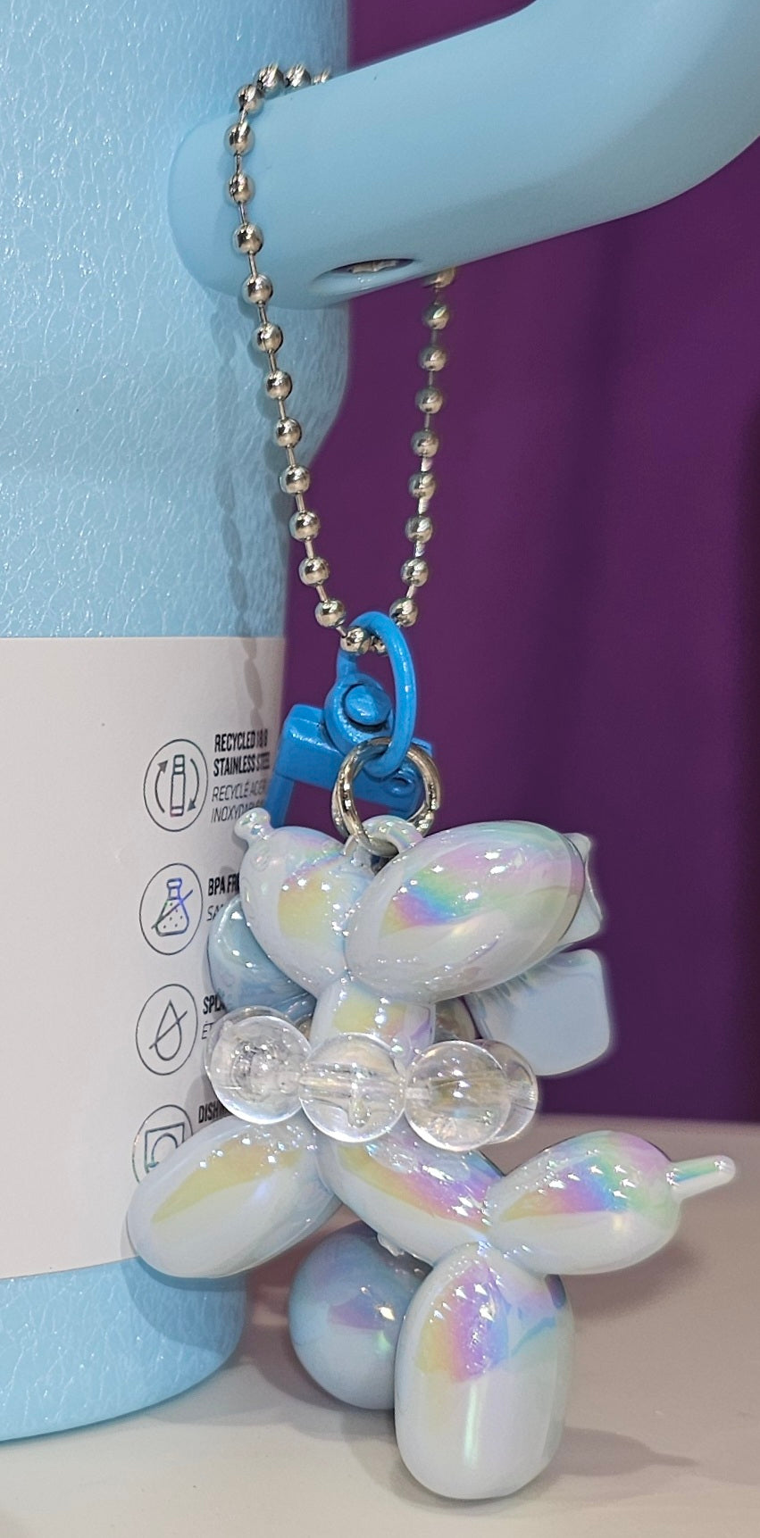 Iridescent Pearlescent Spring Blue Balloon Dog with Ribbon Bow and bead charm pendant. Use to accessorize tumbler straw, tumbler handle, purse, backpack, keychain, or cellphone. 