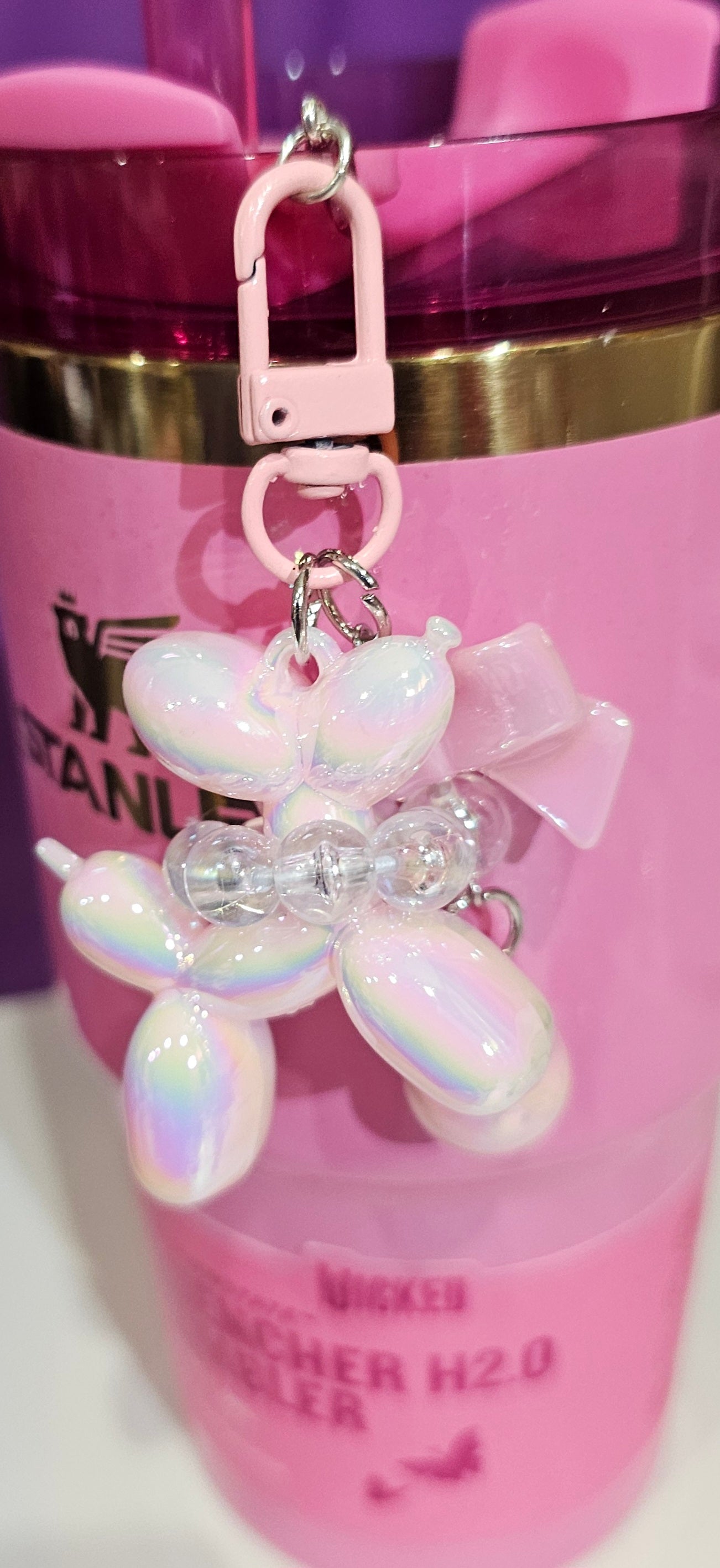 Iridescent Pearlescent Pink Balloon Dog with Ribbon Bow and bead charm pendant. Use to accessorize tumbler straw, tumbler handle, purse, backpack, keychain, or cellphone. 