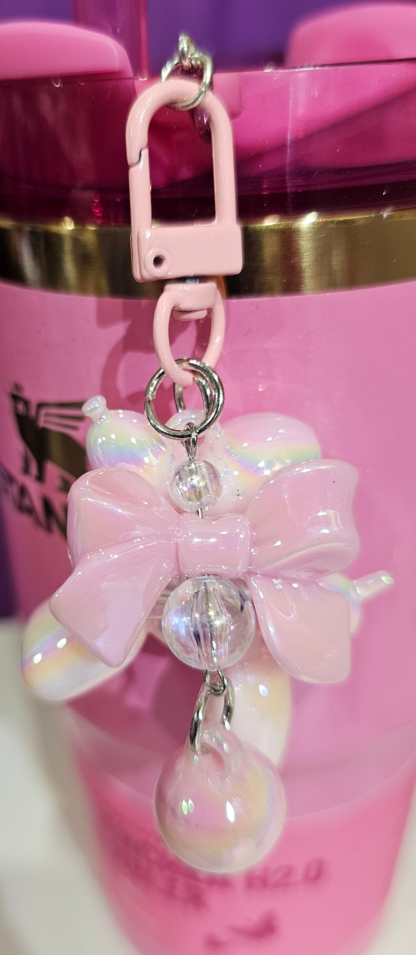 Iridescent Pearlescent Pink Balloon Dog with Ribbon Bow and bead charm pendant. Use to accessorize tumbler straw, tumbler handle, purse, backpack, keychain, or cellphone. 