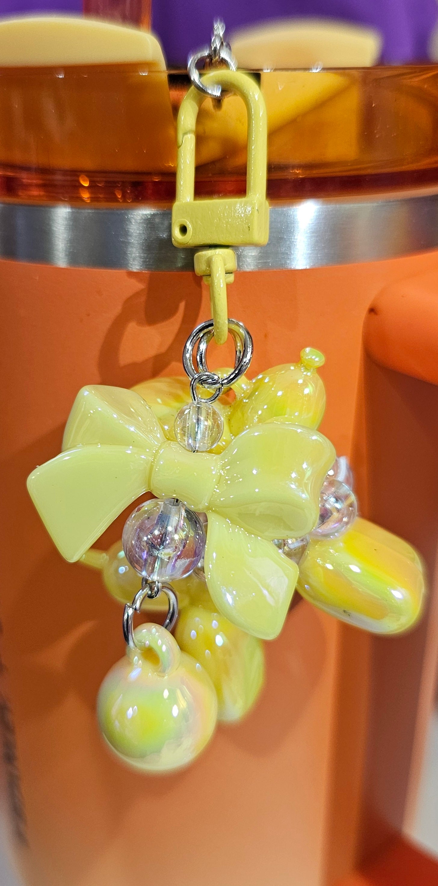 Iridescent Pearlescent Yellow Balloon Dog with Ribbon Bow and bead charm pendant. Use to accessorize tumbler straw, tumbler handle, purse, backpack, keychain, or cellphone. 