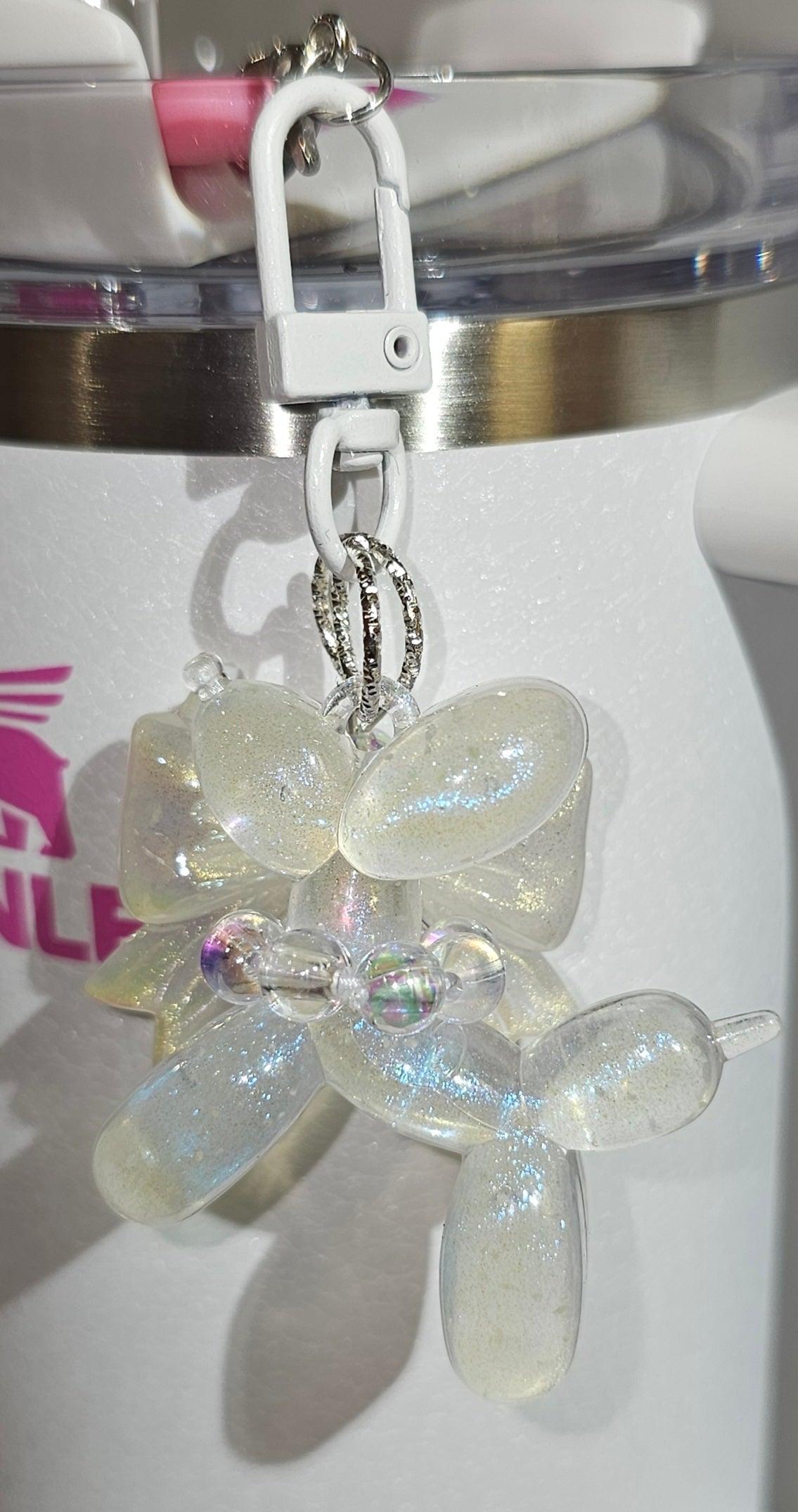 Clear Glow in the Dark Iridescent Pearlescent Glitter Balloon Dog with Croquet Ribbon Bow Charm Pendant for Stanley, Brumate, Simple Modern, Yeti, Hydroflask, Hydrojug, Mini Stanley, Kid's Cup, Kid's Tumbler, Purse, Keychain, or Backpack. 
