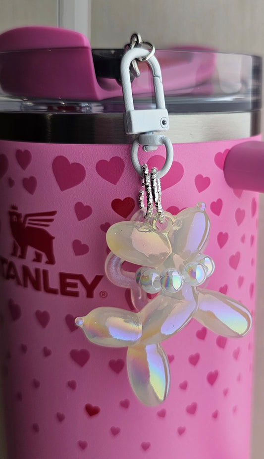 Iridescent Pearlescent white balloon dog charm pendant used as a Stanley straw charm accessory. 