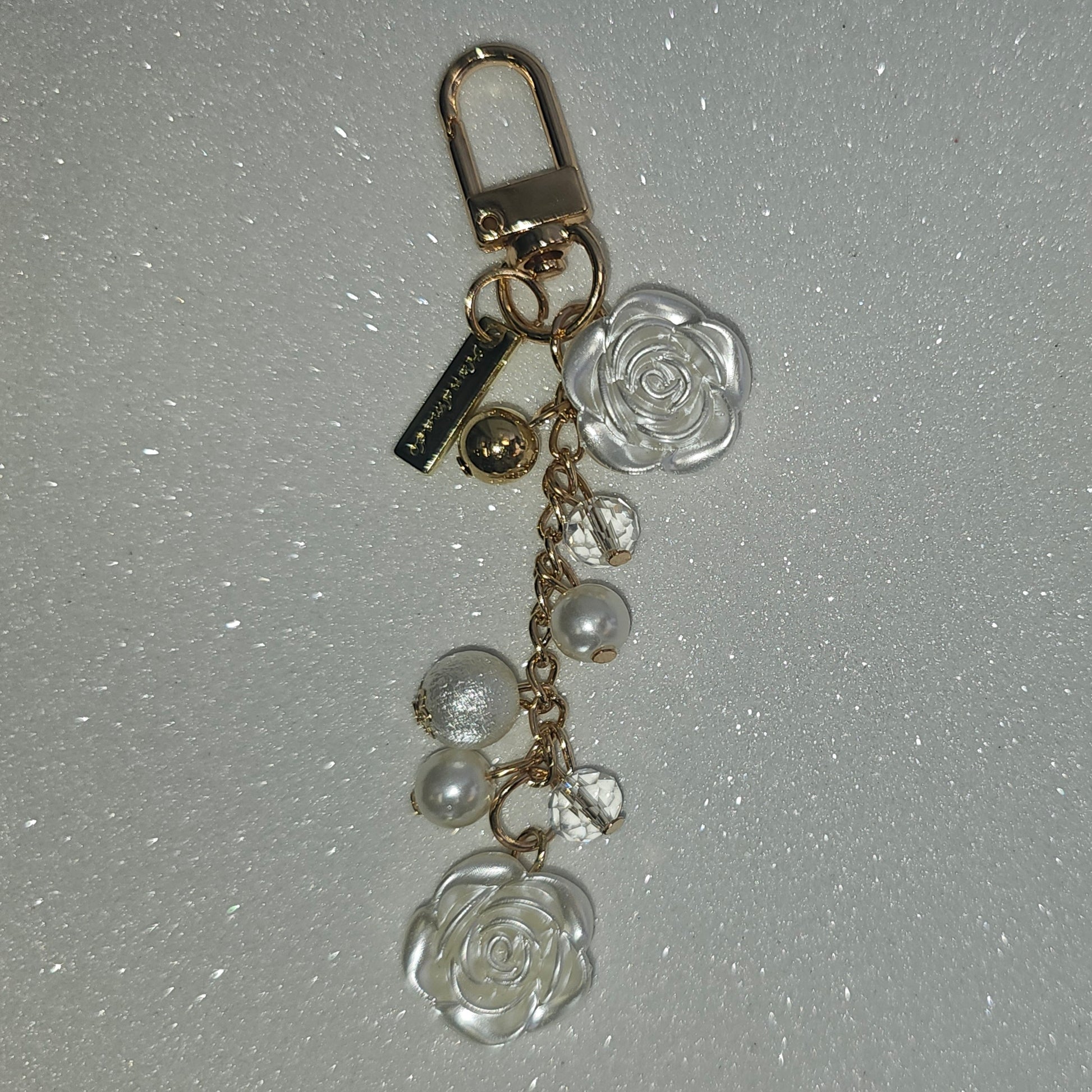 Pearlescent white and gold beaded rose charm. 