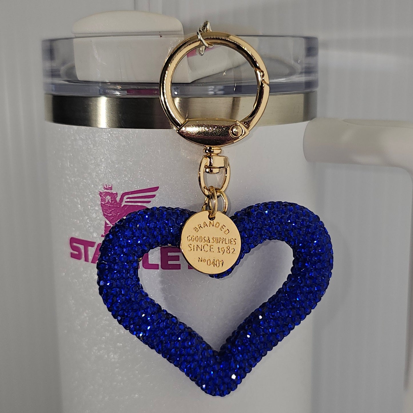 Royal Blue Glitter heart charm with gold swivel keyring tumbler straw charm. Taken with flash. 