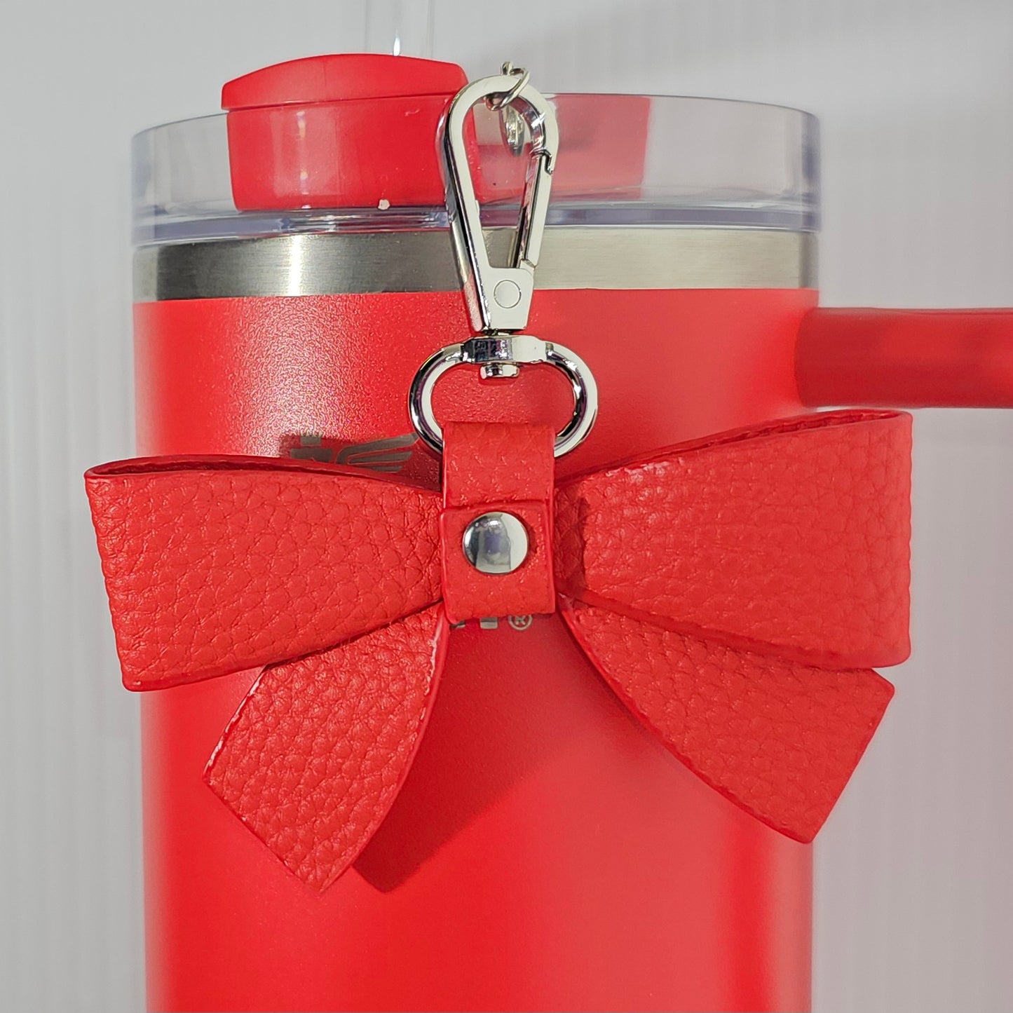 Red Faux leather ribbon bow with silver swivel clasp tumbler straw charm. 