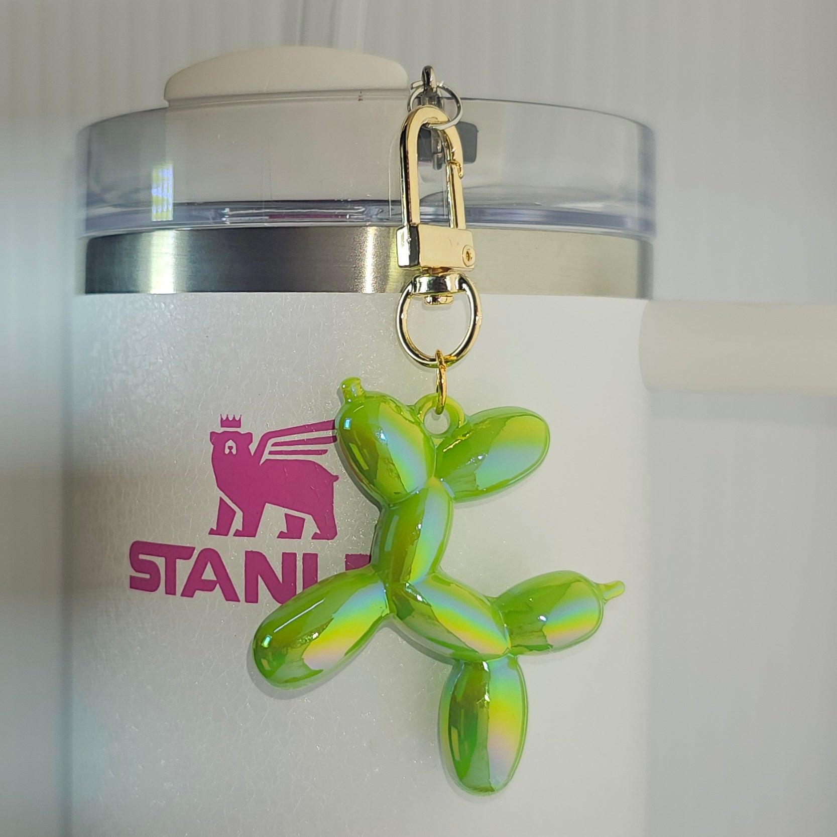 Bright neon green balloon dog tumbler charm. 