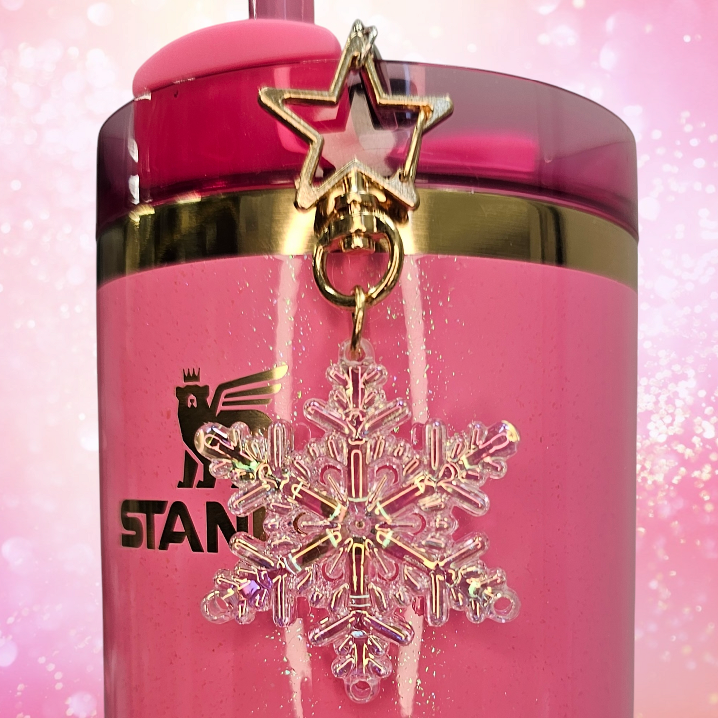 Pearlescent pink Snowflake tumbler straw charm with gold star clasp. Taken without flash. 