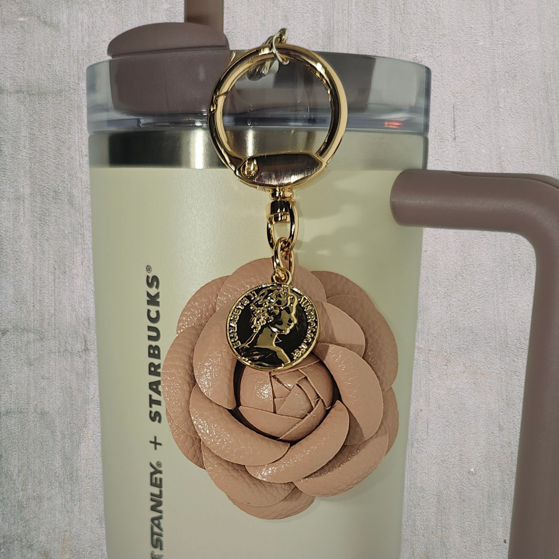 Camel brown Camelia flower with gold swivel keyring tumbler straw charm. 