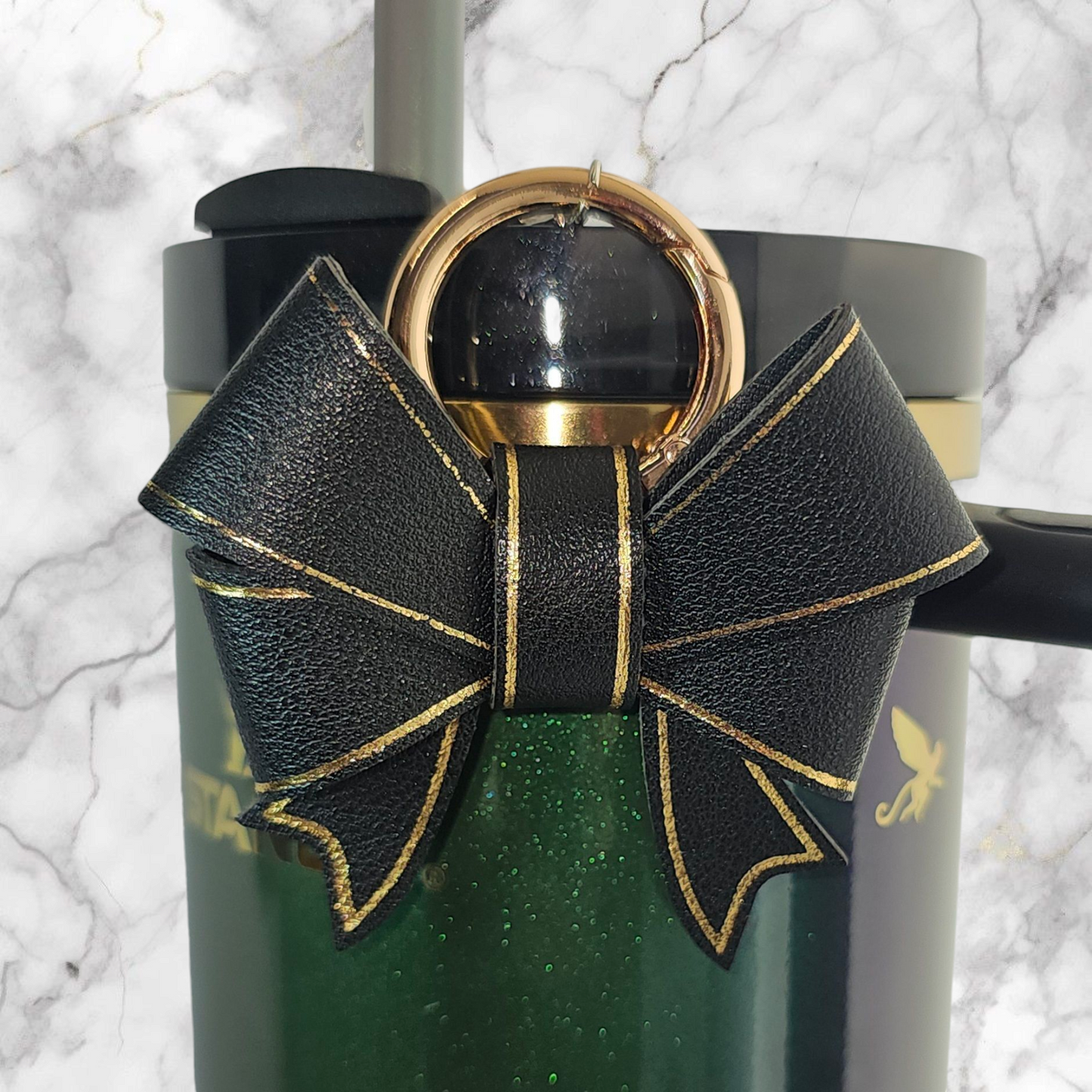 A luxury black faux leather bow trimmed in gold charm pendant that can be used as a charm for your tumbler, tumbler straw, purse, bag, keychain, backpack, or cellphone. 