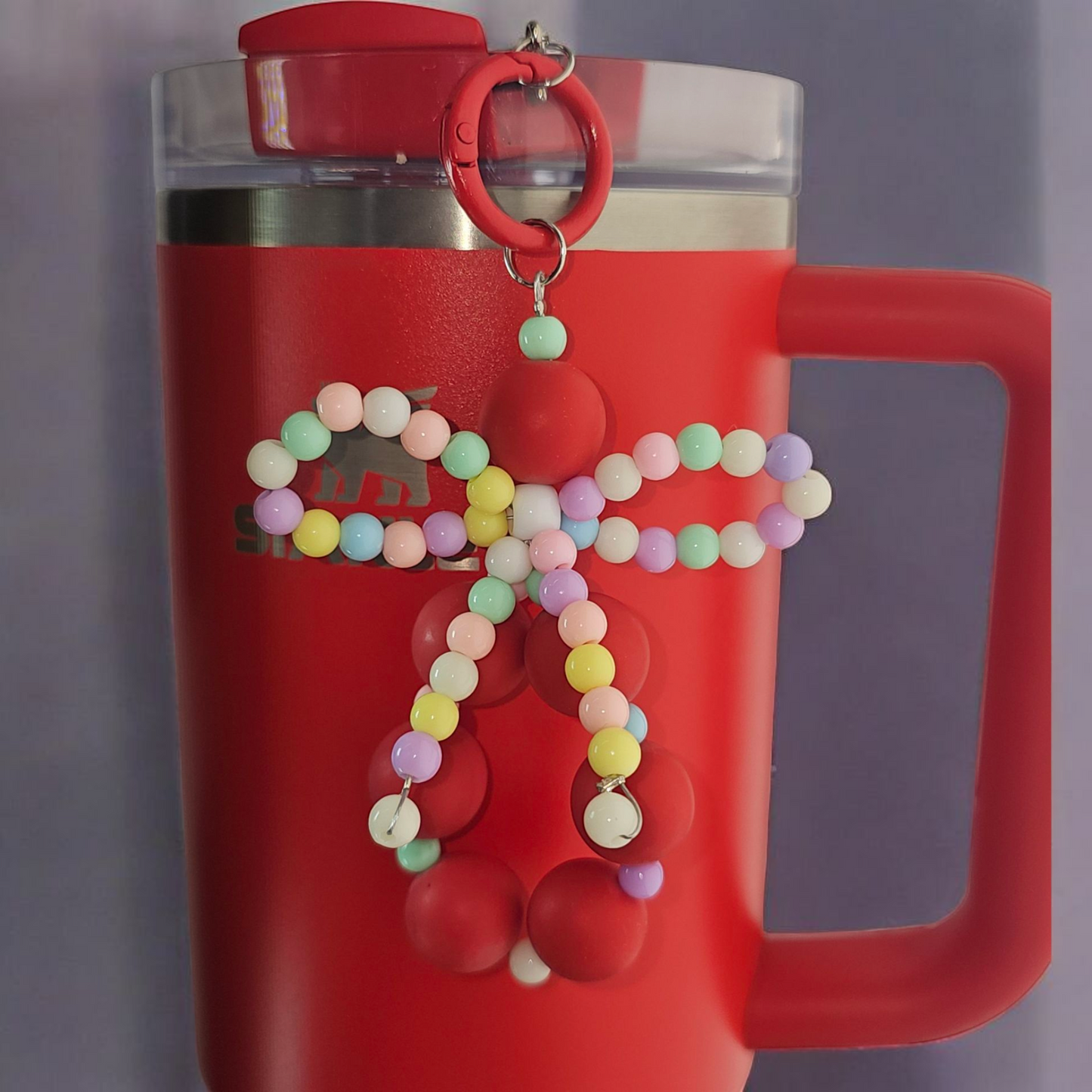 Jump red beaded charm pendant with multicolor pastel beaded ribbon bow tumbler charm. 