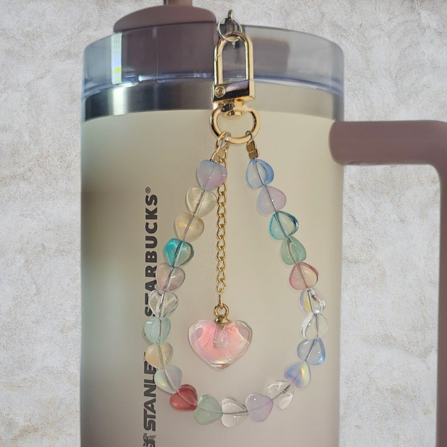 Deluxe Crystal Heart Beaded Tumbler Charm. 
Iridescent Pearlescent Pink Crystal Heart Beaded Tumbler Charm. 

Beads are multicolored. There are 3 styles so please reference the image linked to the style number when choosing. 