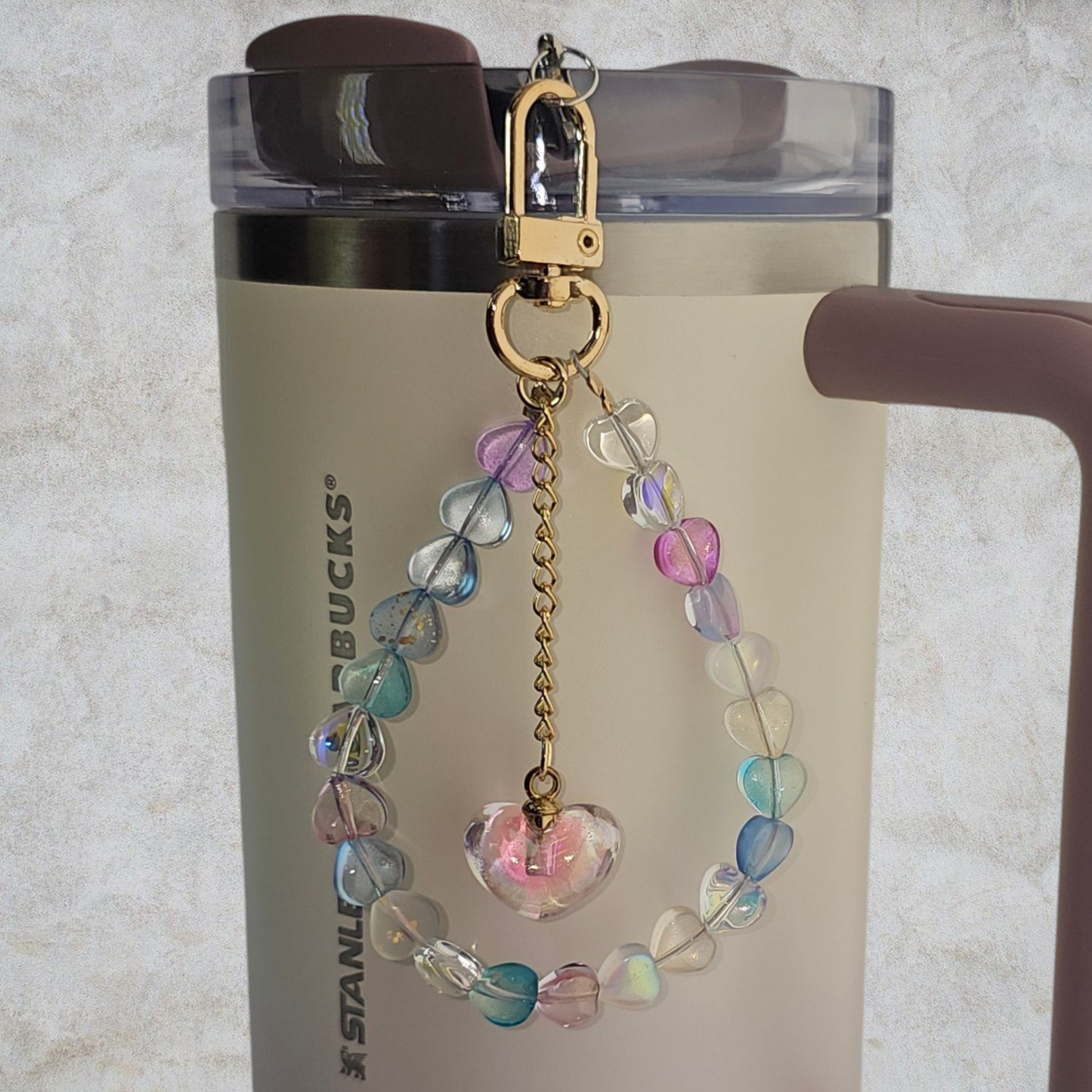 Deluxe Crystal Heart Beaded Tumbler Charm. 
Iridescent Pearlescent Pink Crystal Heart Beaded Tumbler Charm. 

Beads are multicolored. There are 3 styles so please reference the image linked to the style number when choosing. 