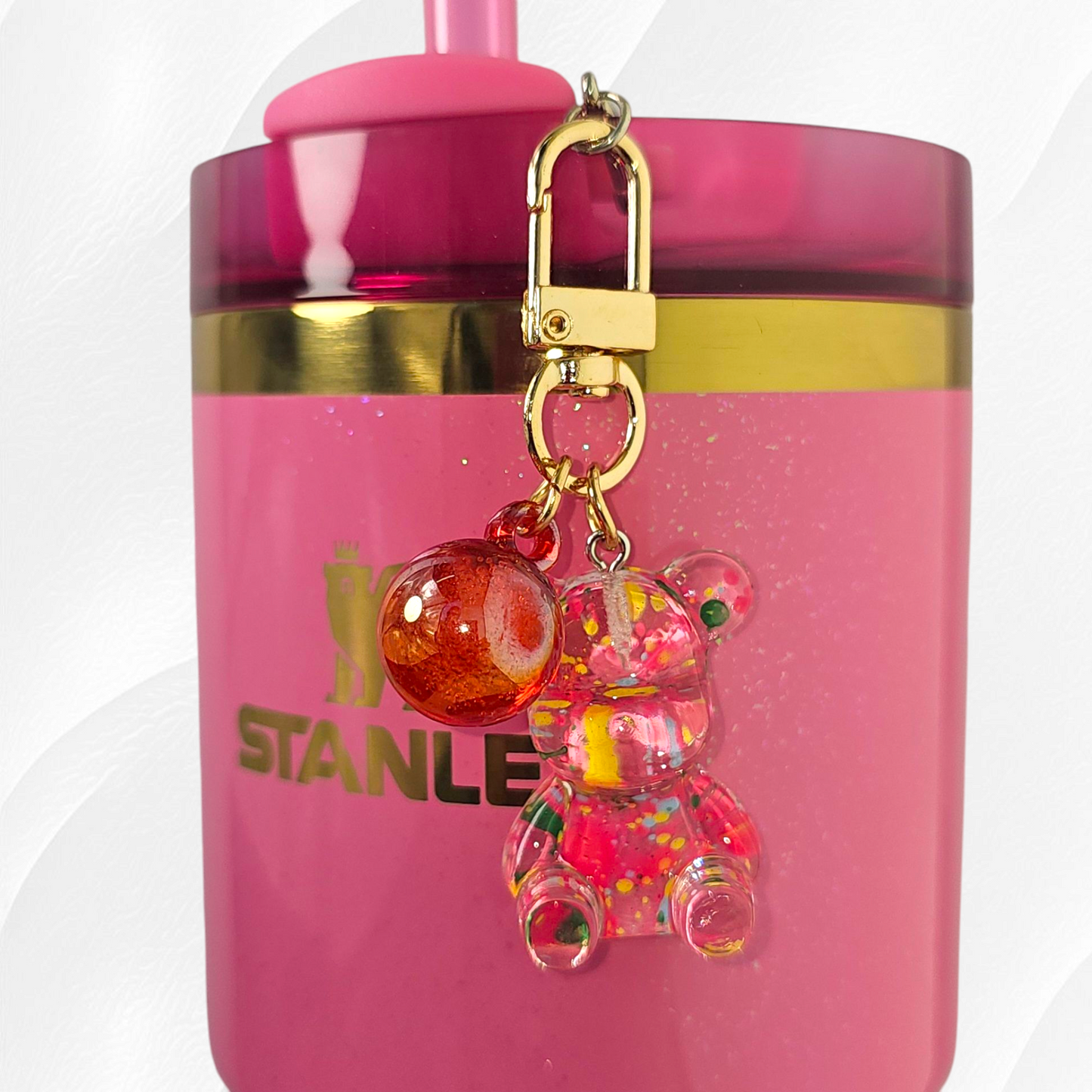 Transparent pink teddy bear with green and yellow specks. Use as a tumbler, purse, or keychain charm. 