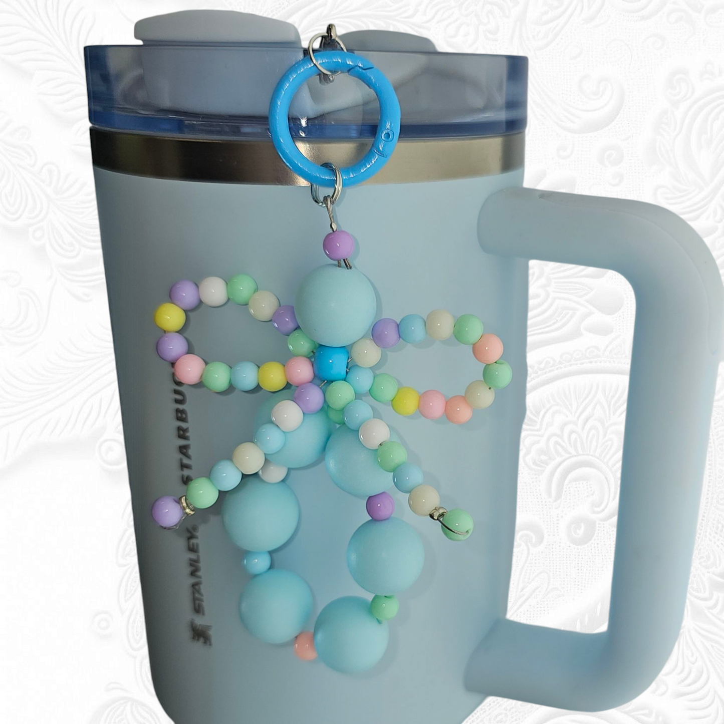 Jump blue beaded charm pendant with multicolor pastel beaded ribbon bow tumbler charm. 
