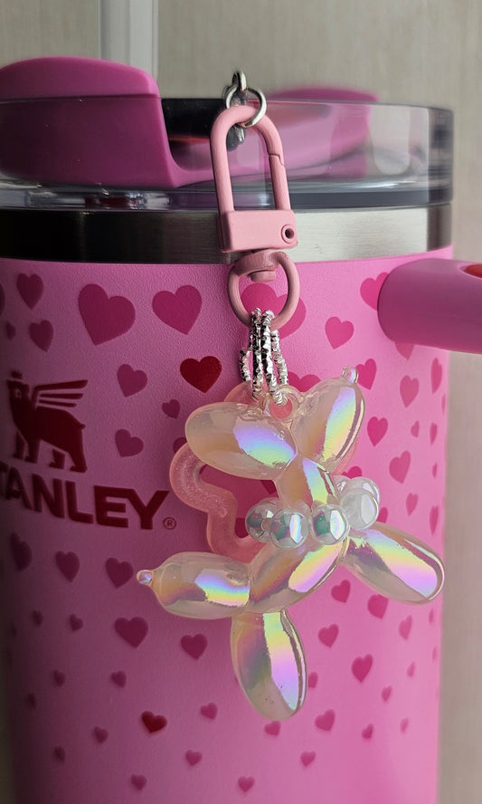 Iridescent Pearlescent Blush Pink balloon dog charm pendant used as a Stanley straw charm accessory. 