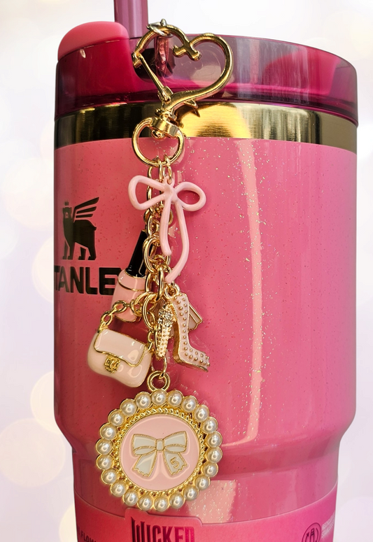 Luxury tumbler straw charm dangle for the classy Diva. 

Colors are gold, white, and pink. 

Charms consist of pink fingernail polish, glitter high heel, white pearl #5 bow, pink bow, and pink dress. 