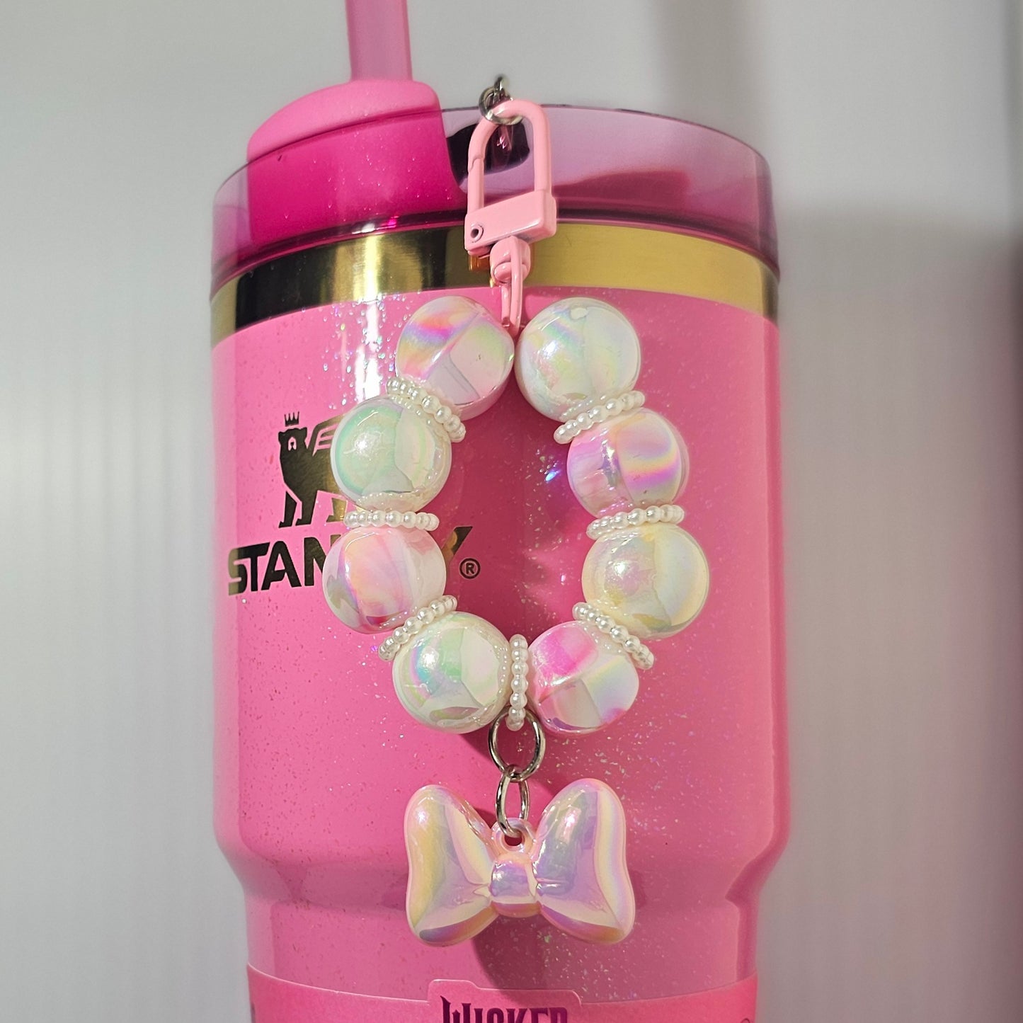 Pink and white beaded bow tumbler straw charm. 