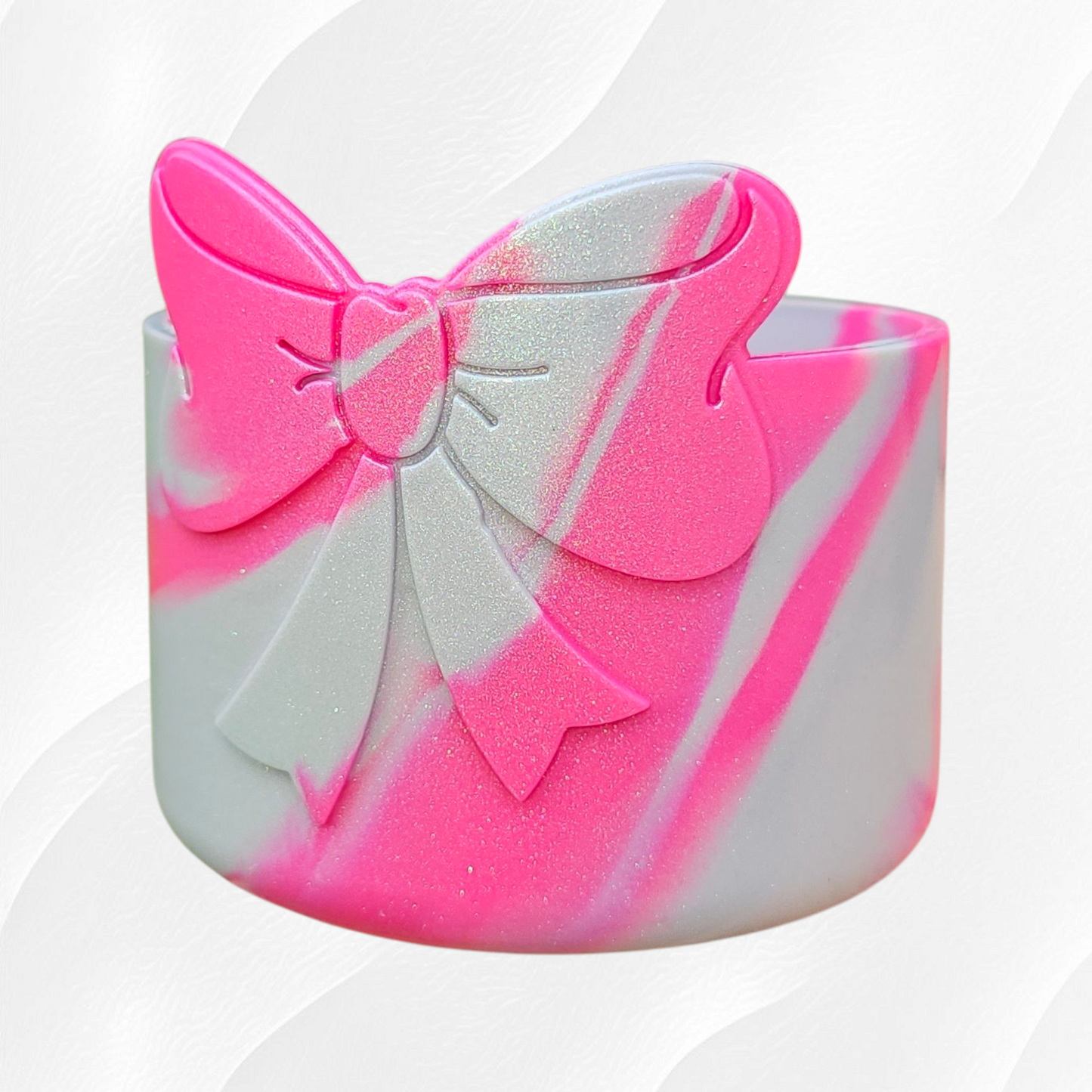 Pink and Silver Shimmer colors swirled on a silicone bow tumbler boot. 