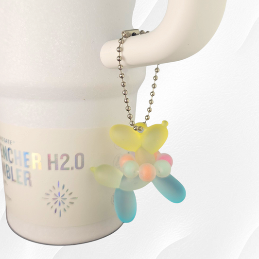 Pool Blue & Yellow Ombre Balloon Dog wearing a beaded necklace tumbler charm. 