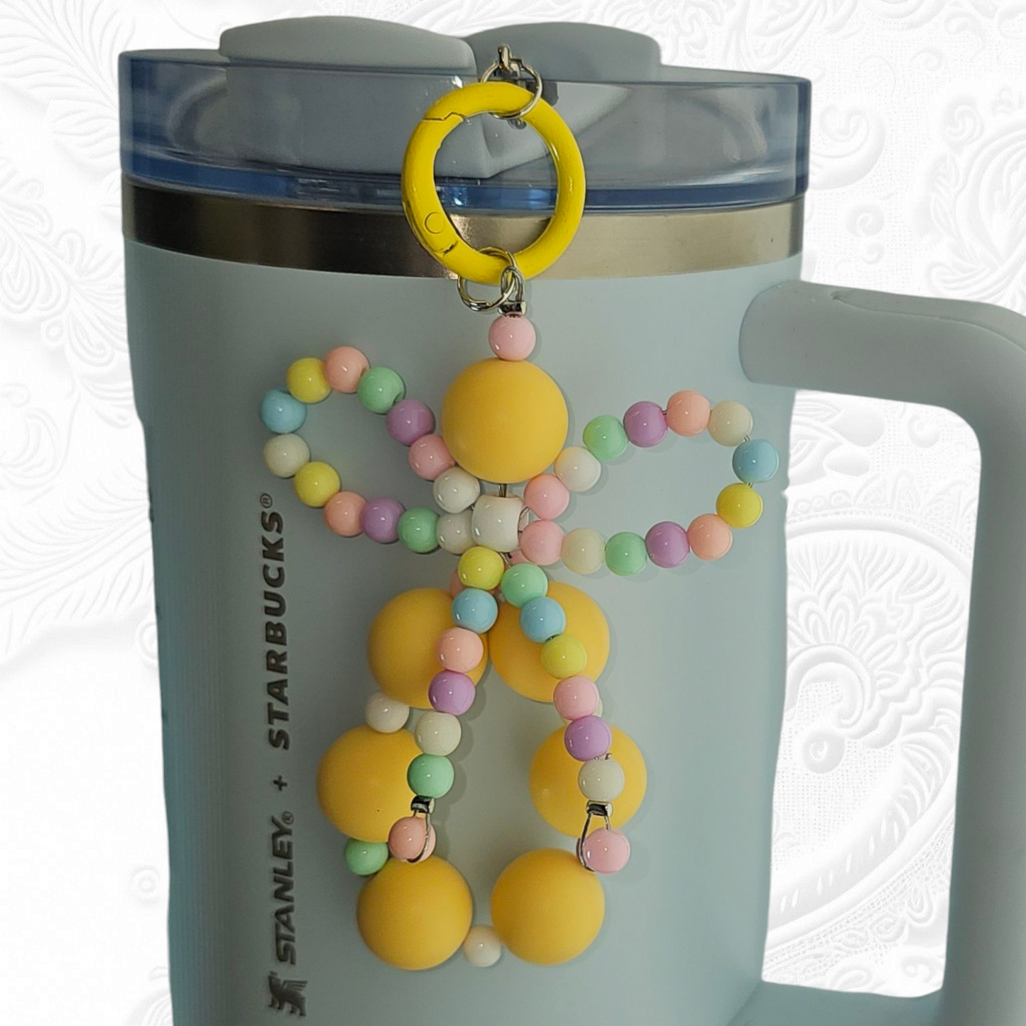 Jump yellow beaded charm pendant with multicolor pastel beaded ribbon bow tumbler charm. 