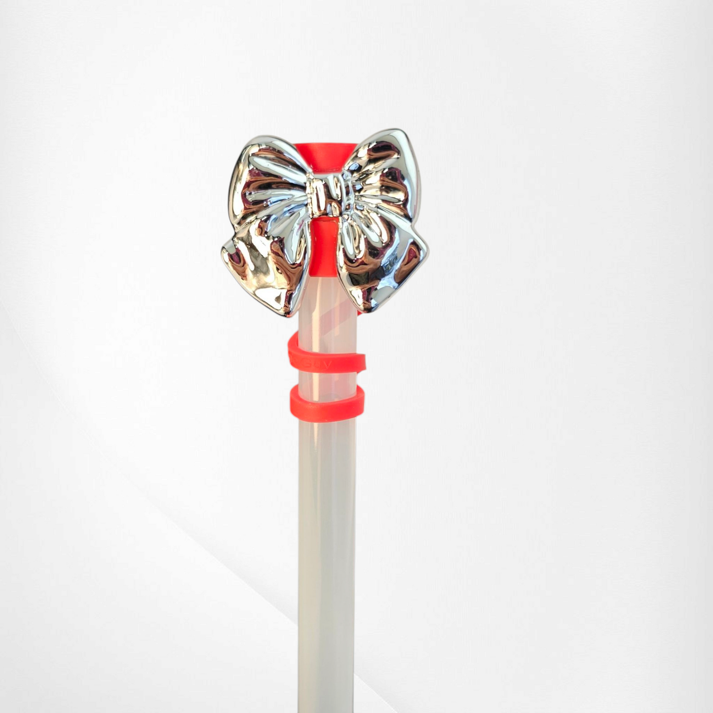 Shiny Silver Bow Silicone Straw Topper. Red straw cap base. 