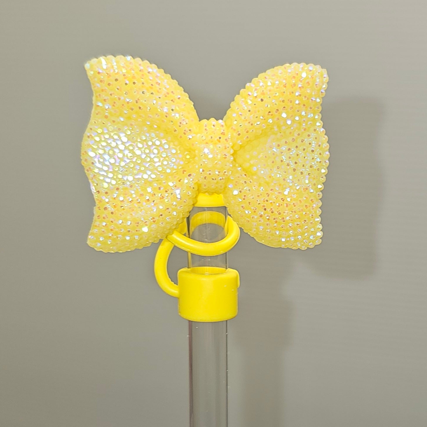 Glitter Yellow bow tie with Yellow Silicone base - Straw Topper  - Straw Cover - Fits 10mm and Stanley Straws. 
Taken with camera flash. 