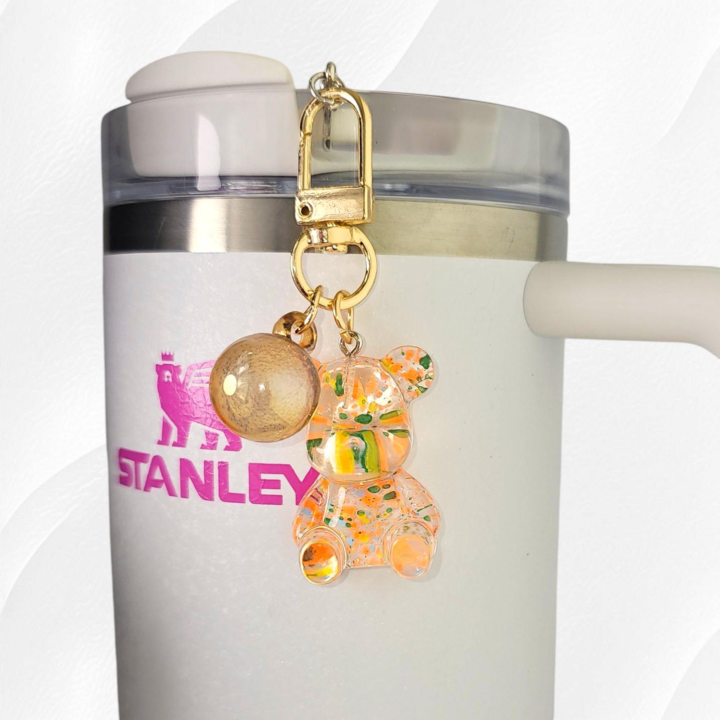 Transparent orange teddy bear with green and yellow specks. Use as a tumbler, purse, or keychain charm. 