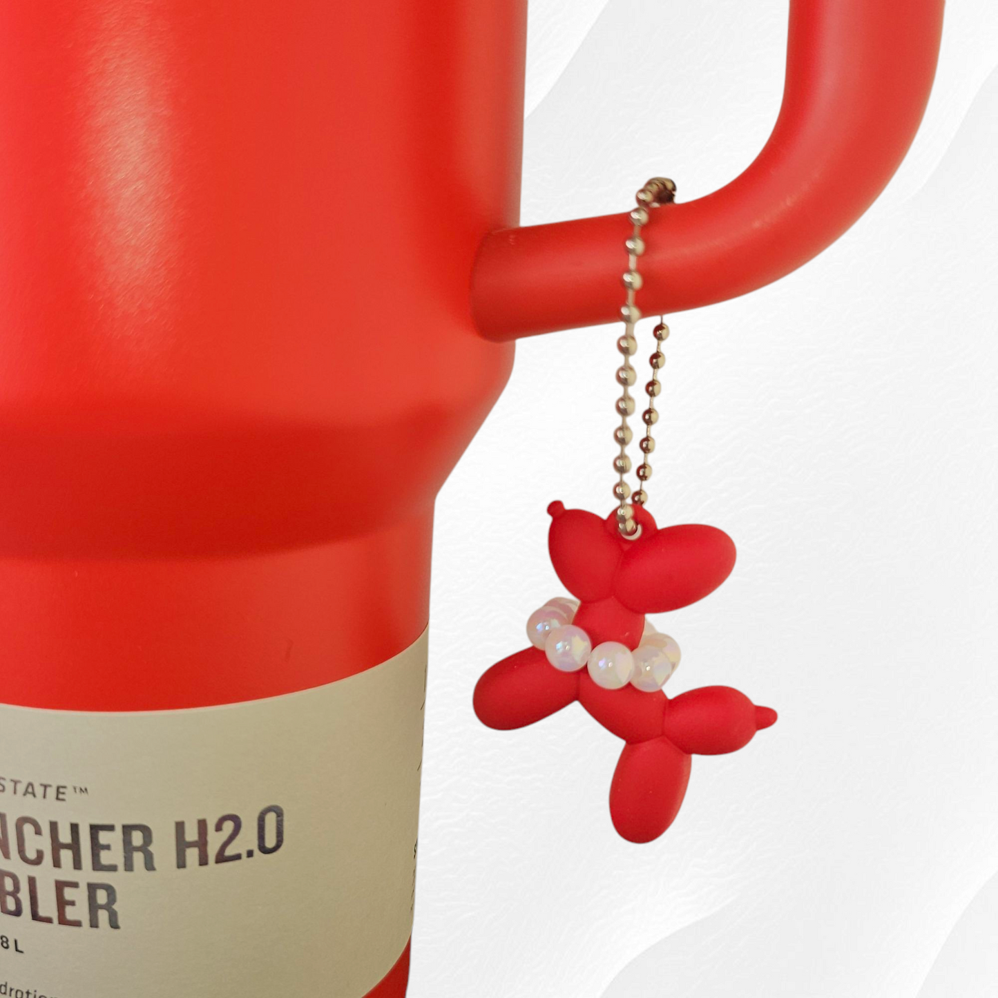Red Balloon Dog wearing white pearl necklace cup handle charm. 