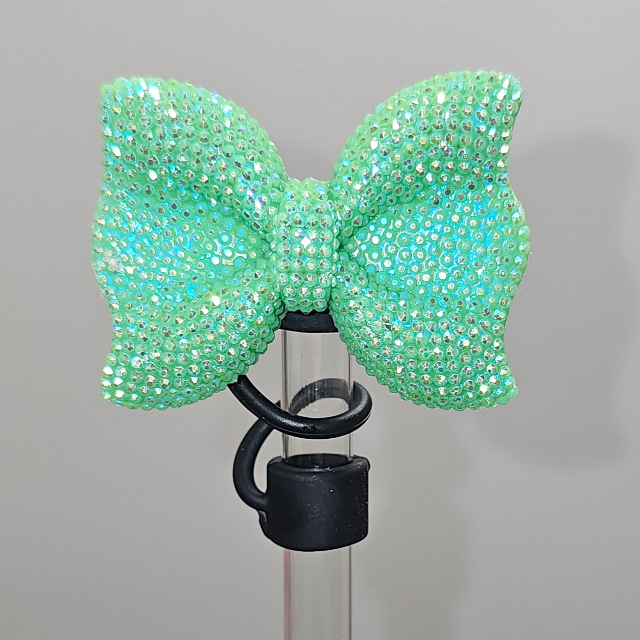 Glitter green bow tie with black Silicone base - Straw Topper  - Straw Cover - Fits 10mm and Stanley Straws.  Taken with camera flash. 