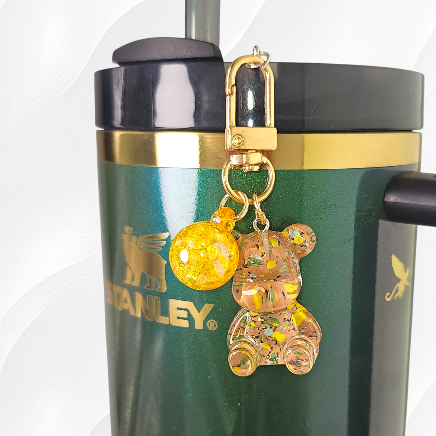 Transparent gold teddy bear with green and yellow specks. Use as a tumbler, purse, or keychain charm. 