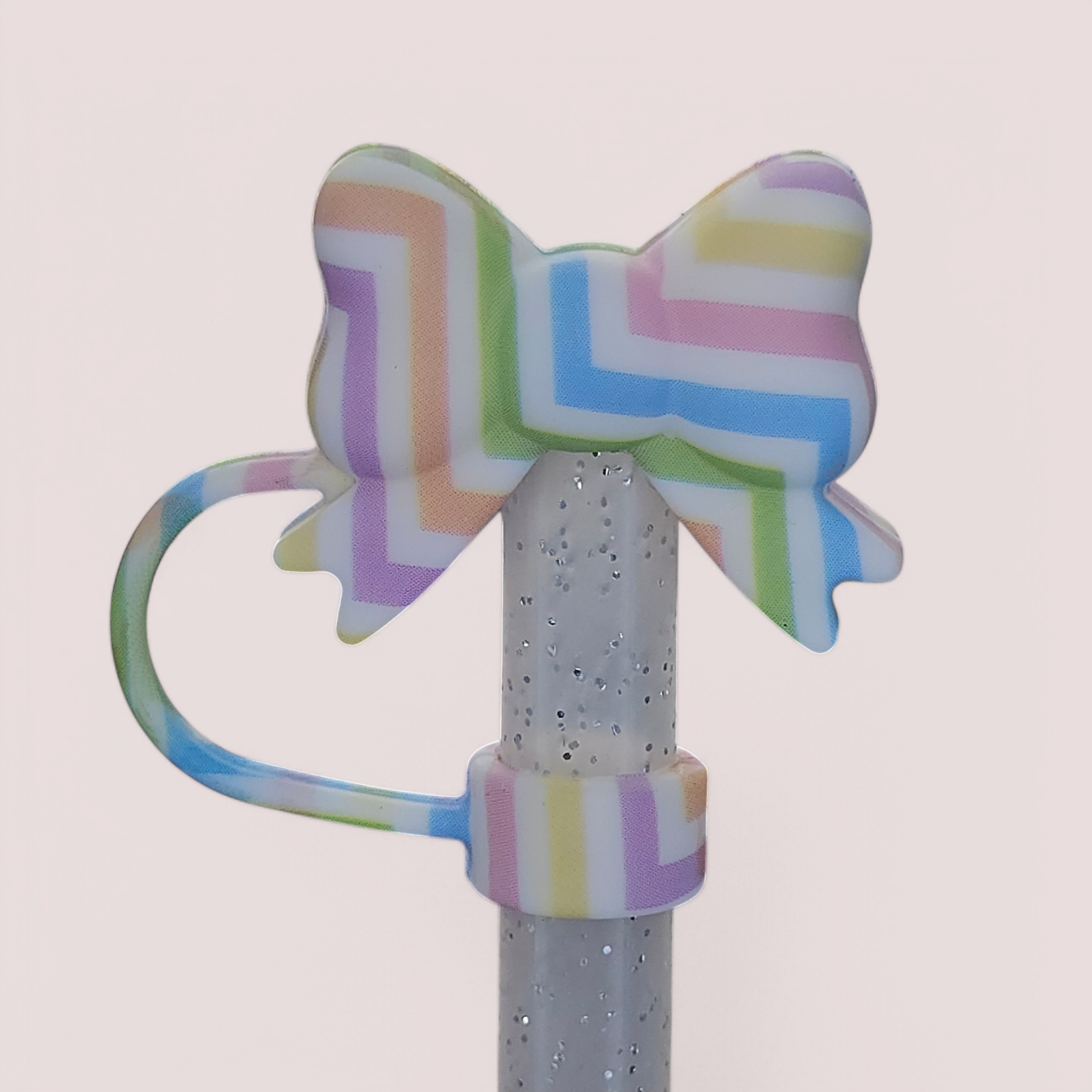 Coquette Ribbon Bow Silicone Straw Topper  - Easter Egg. Stripe colors are pink, purple, blue, green, orange, and yellow with a White background. 