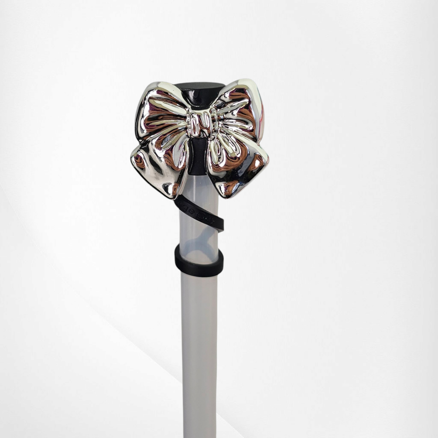 Shiny Silver Bow Silicone Straw Topper. Black straw cap base. 