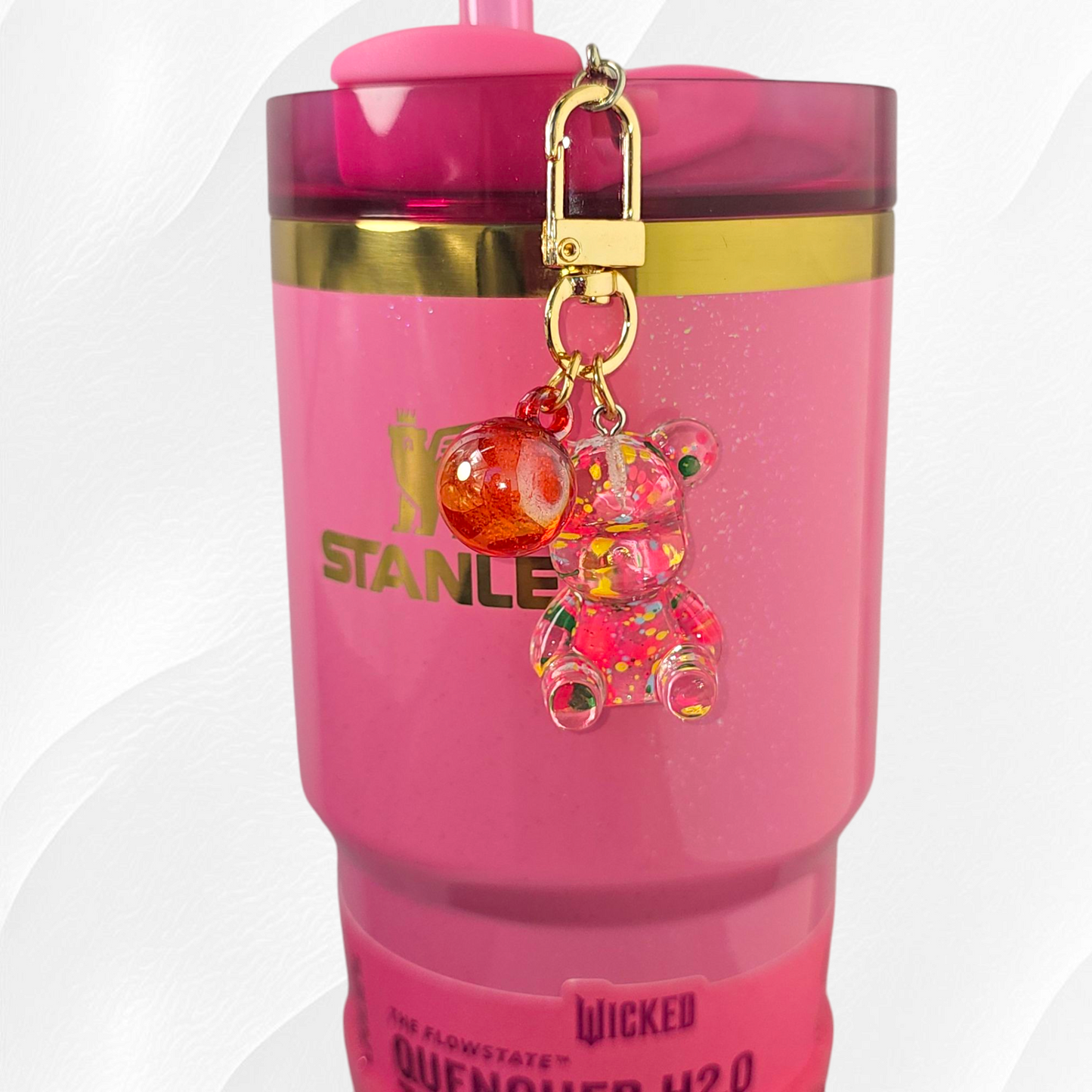 Transparent pink teddy bear with green and yellow specks. Use as a tumbler, purse, or keychain charm. 