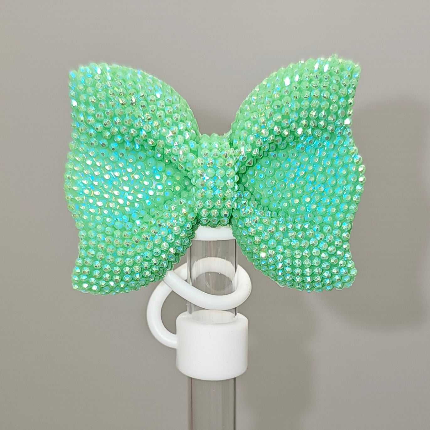 Glitter green bow tie with white Silicone base - Straw Topper  - Straw Cover - Fits 10mm and Stanley Straws. Taken with camera flash. 